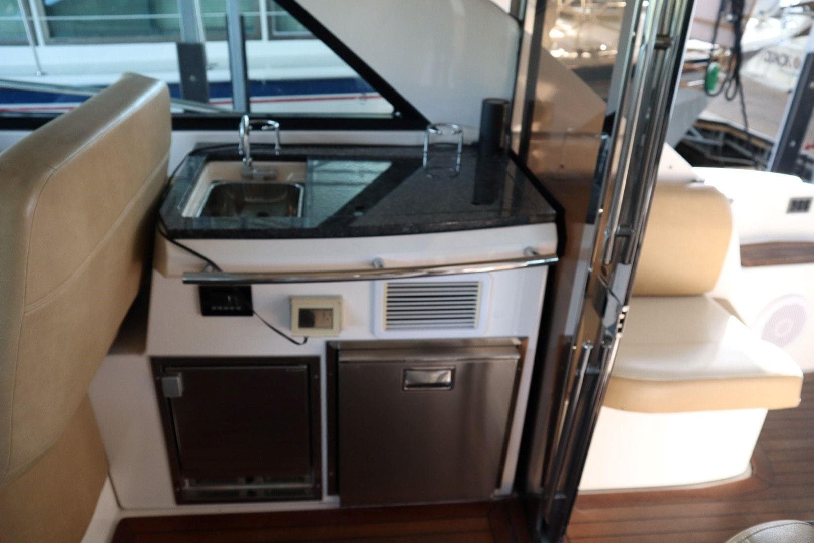 Interior of 2010 Regal 46 Sport Coupe yacht with kitchenette and seating area.