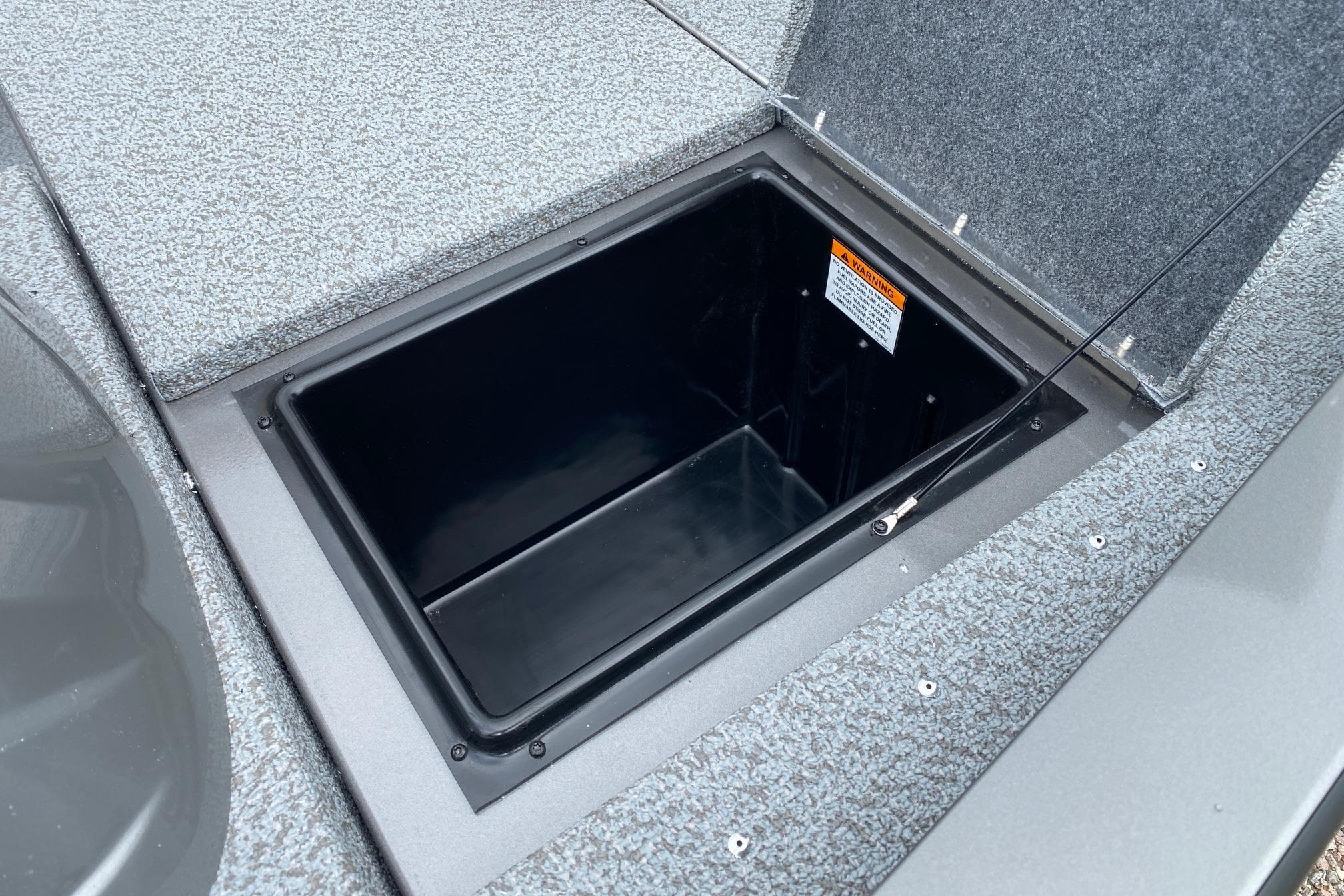 Open storage compartment on 2026 G3 Sportsman 1610 boat deck.