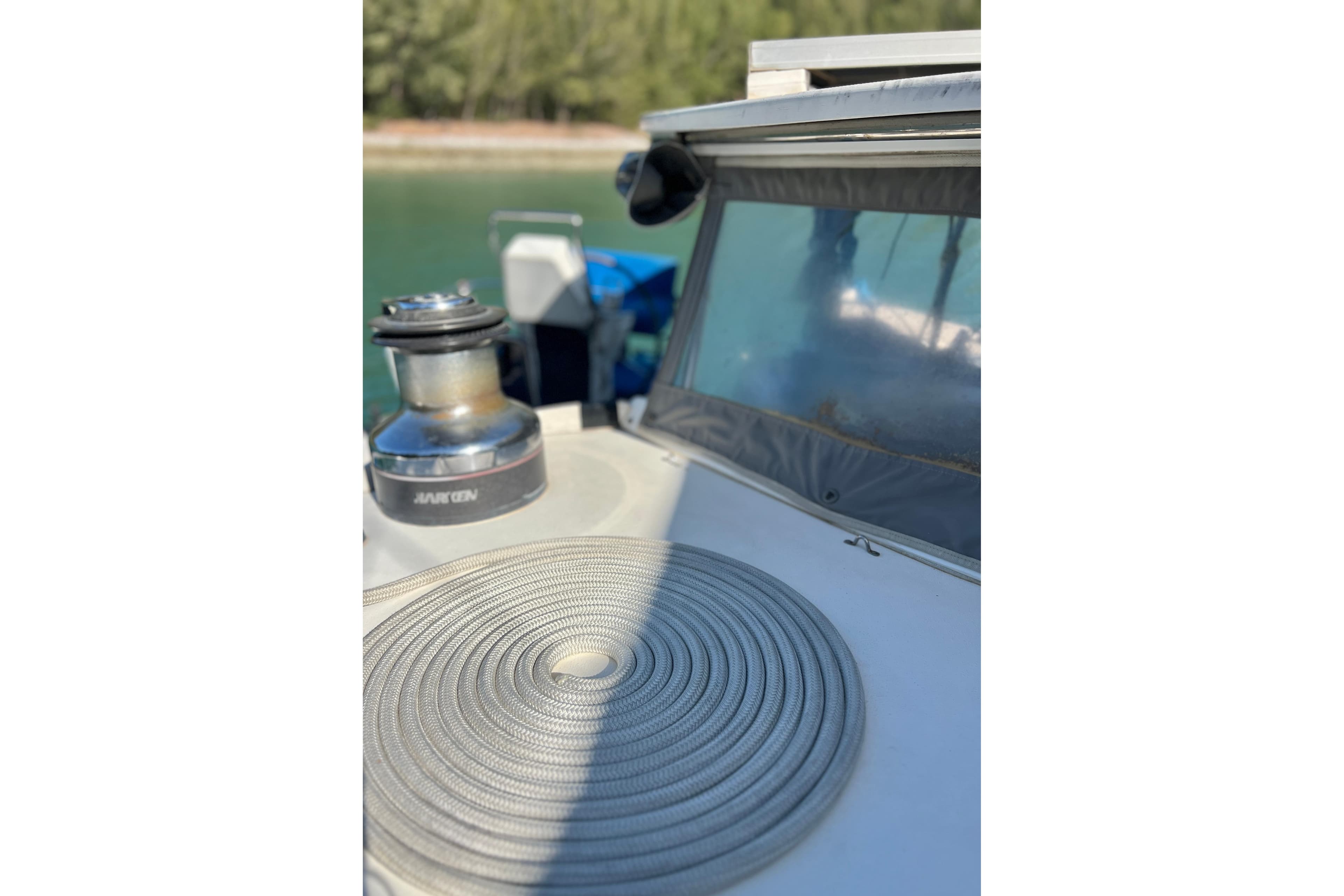 A 2005 Concordia Dickson 69 boat deck with coiled rope and winch.