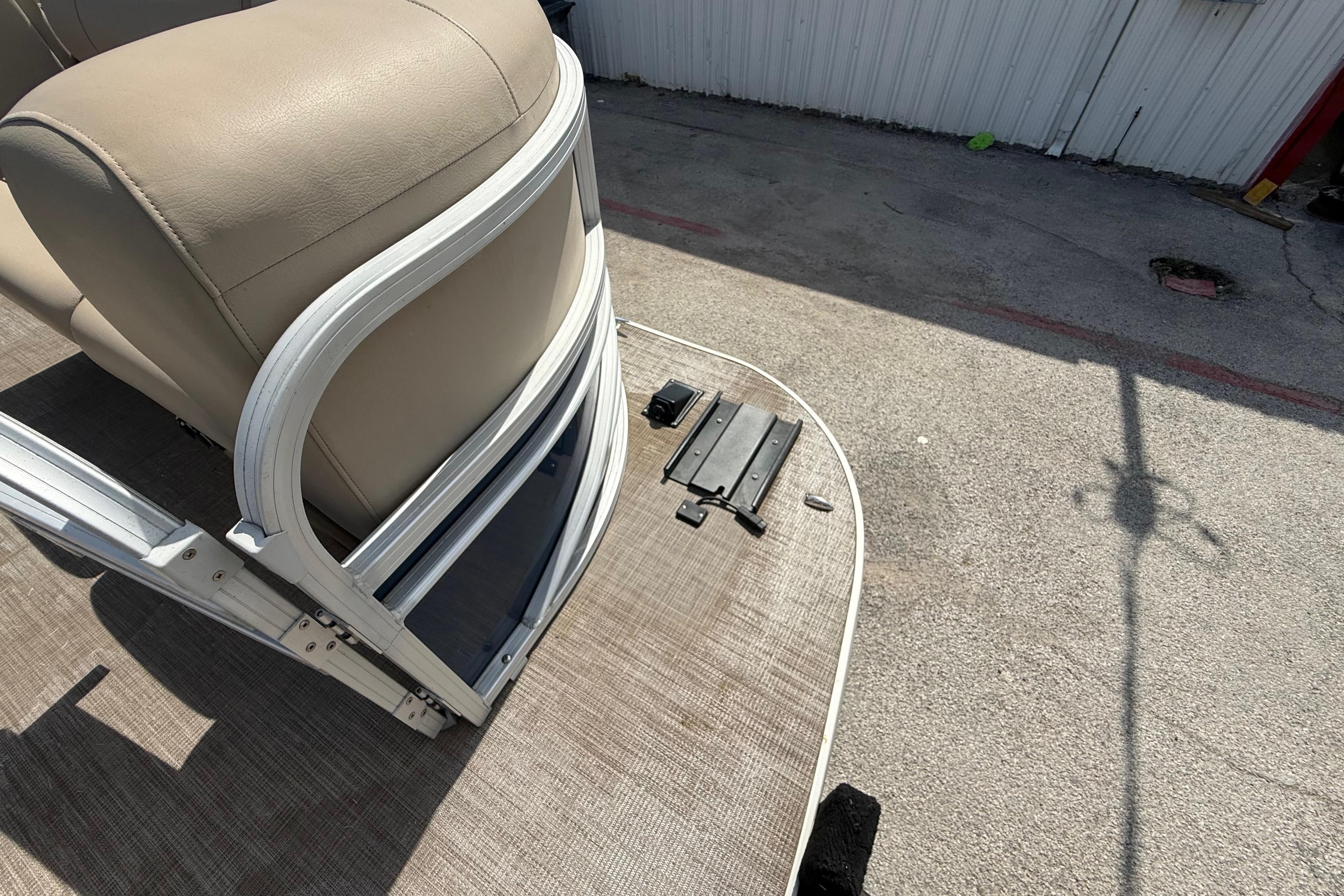2021 Sun Tracker SportFish 22 DLX boat interior with beige seating and deck details.
