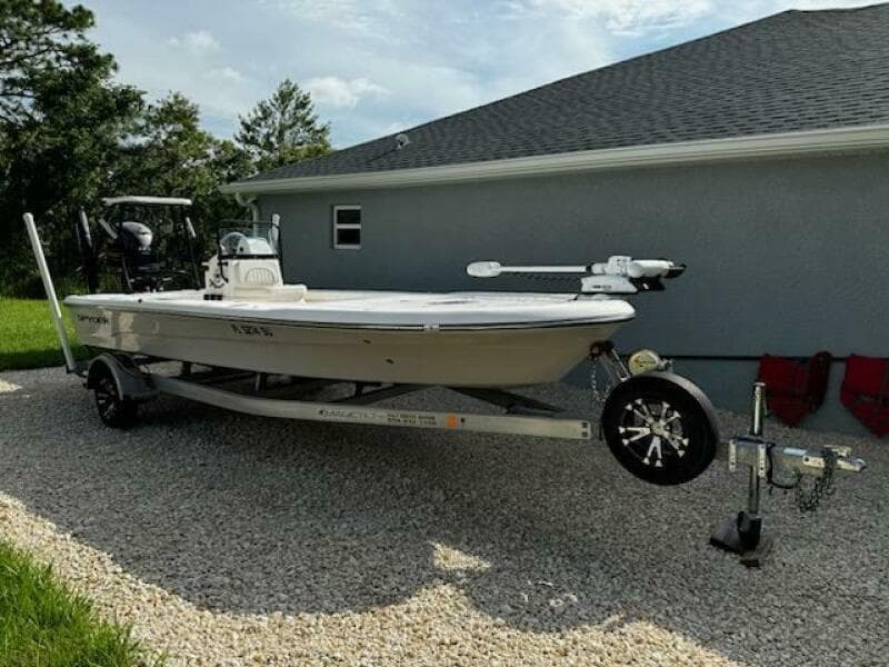 2019 Spyder FX19 Vapor boat on trailer, parked beside a house.