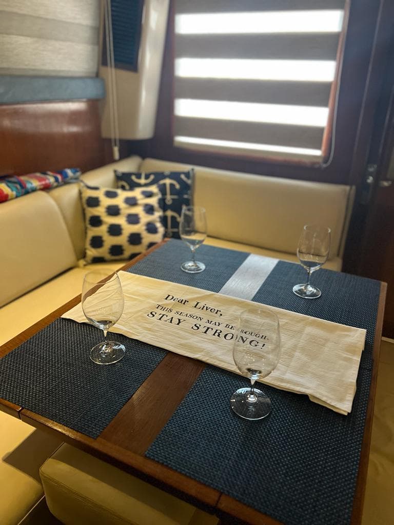 Interior of 1994 Luhrs 380 Tournament yacht with dining table and nautical decor.