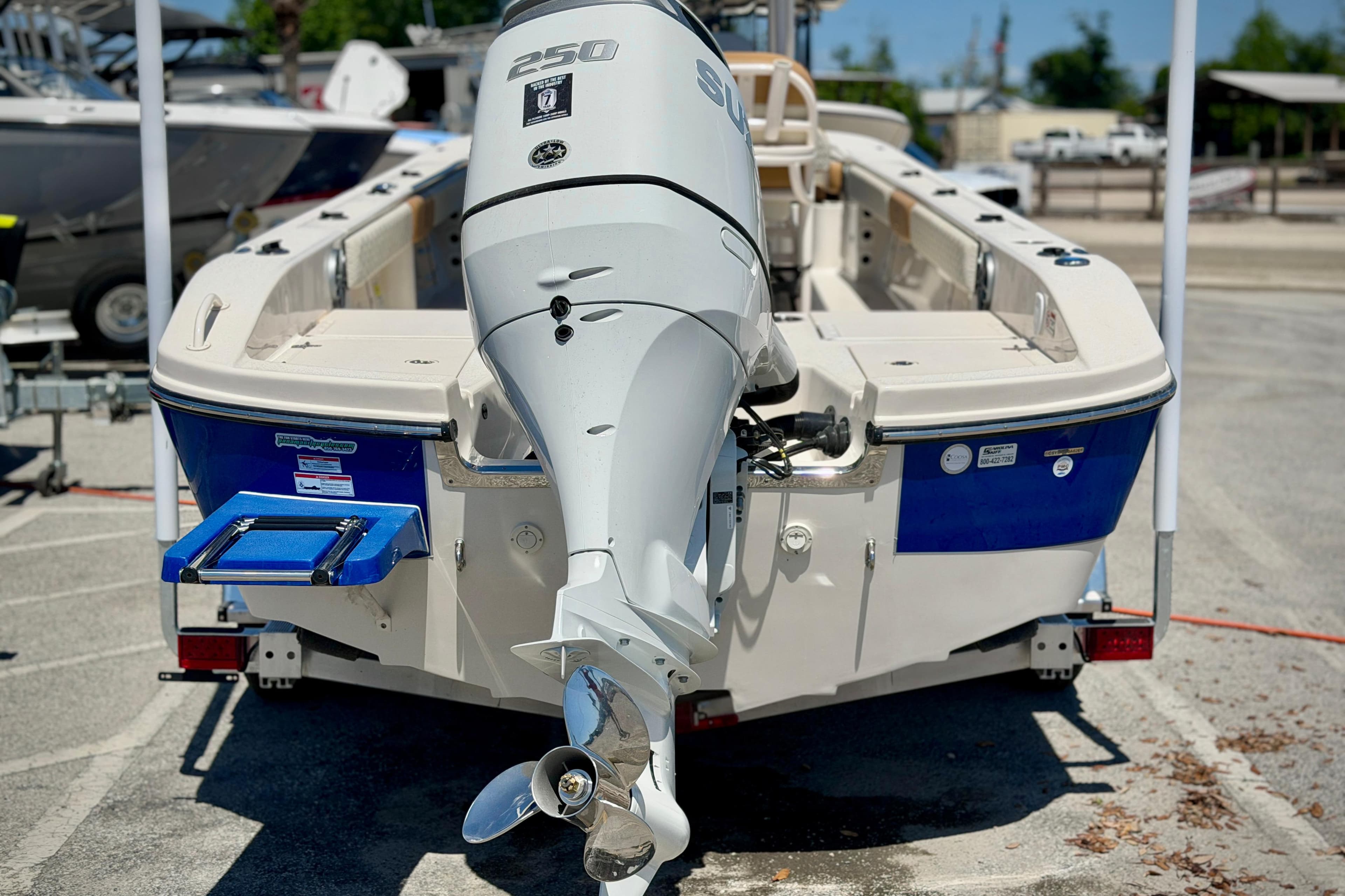 2026 Carolina Skiff 24 Ultra Elite boat with powerful outboard motor, parked on trailer.