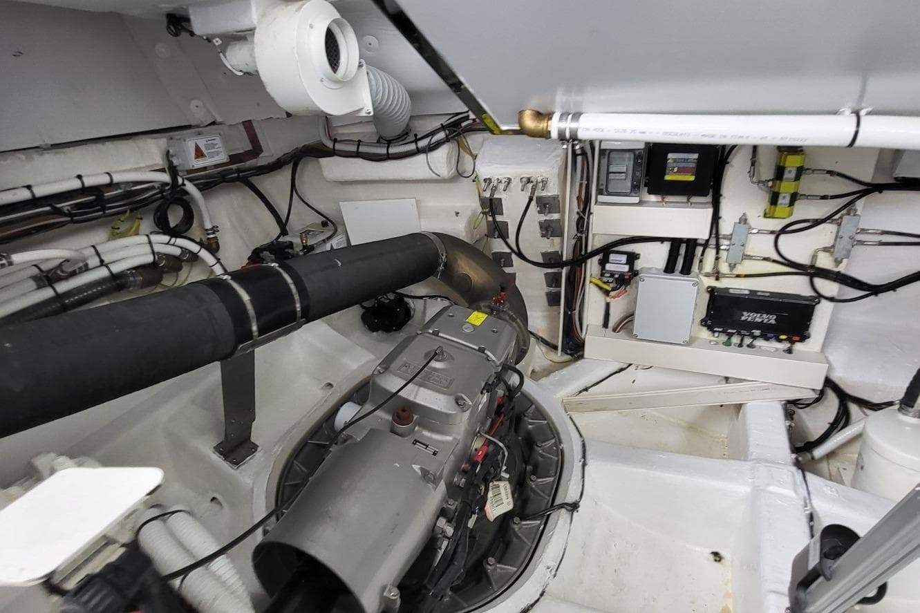 Engine room of 2023 VanDutch 56 yacht, showcasing mechanical components and wiring.
