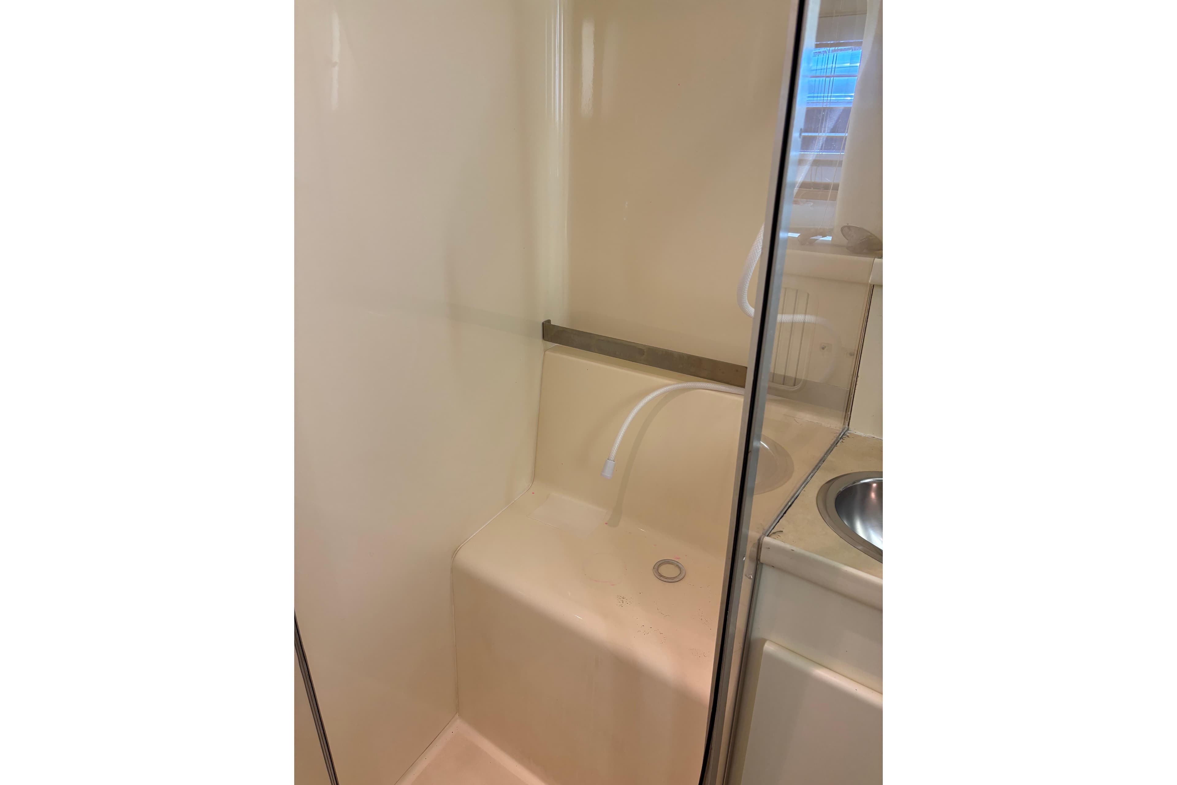 Shower area in 1997 Carver 400 Cockpit Motor Yacht, featuring a compact design.
