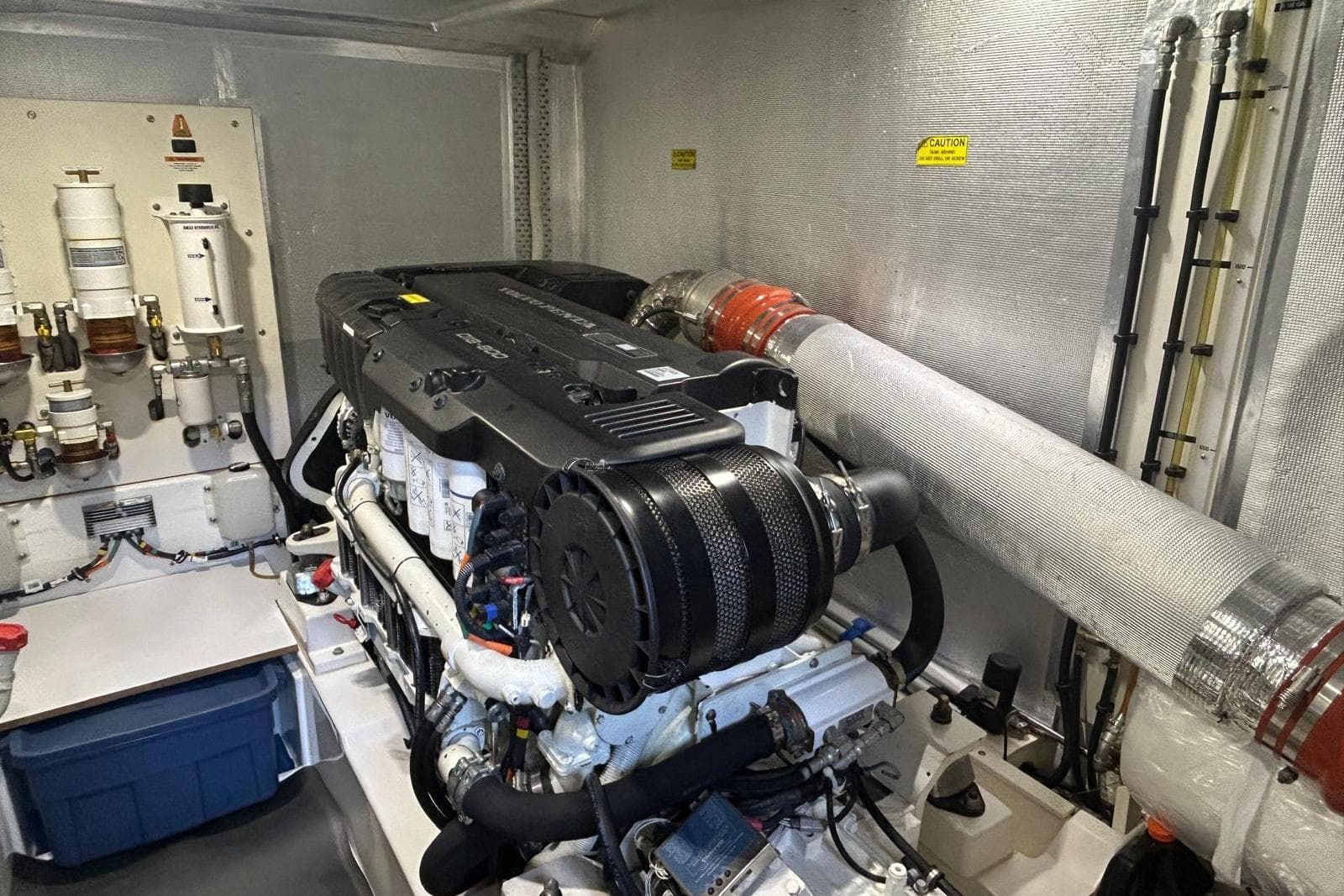 Engine room of 2015 Maritimo S62 yacht, featuring a powerful marine engine setup.