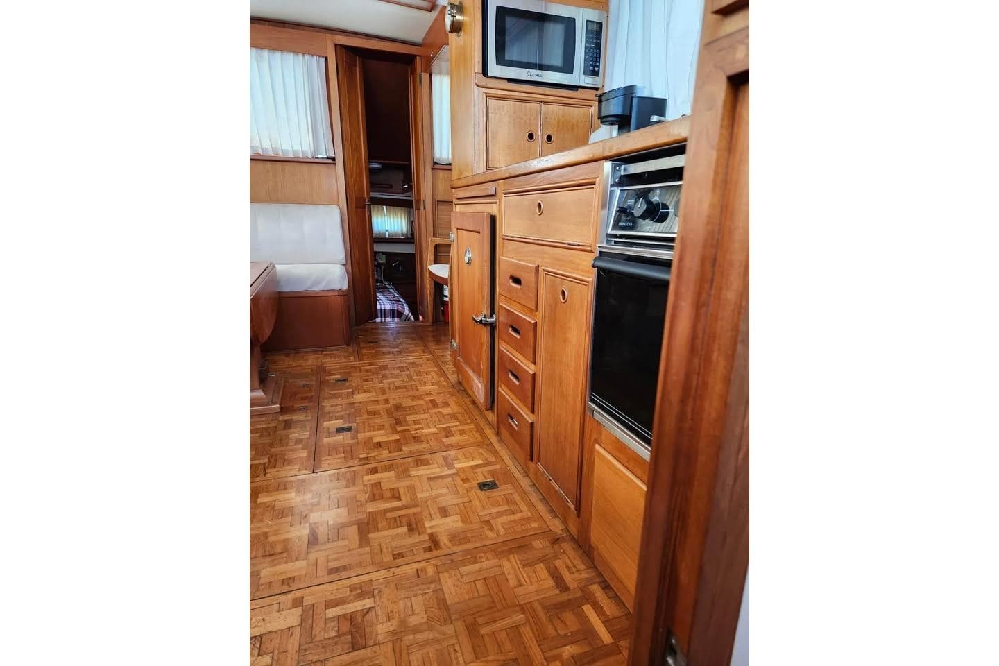 Interior of 1996 Grand Banks 36 Sedan with wood cabinetry and parquet flooring.