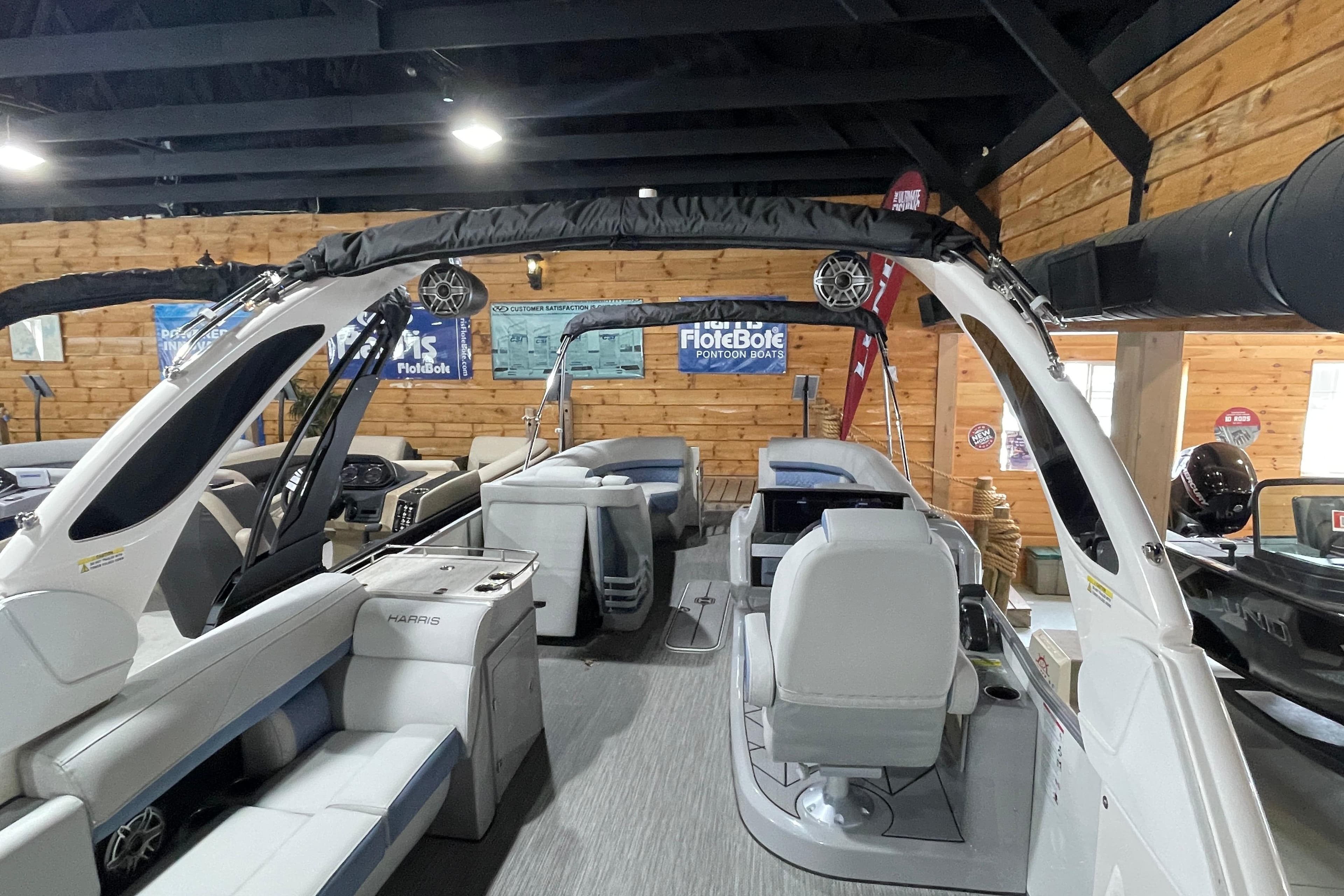 2026 Harris Grand Mariner SLEC 250 pontoon boat interior in showroom setting.