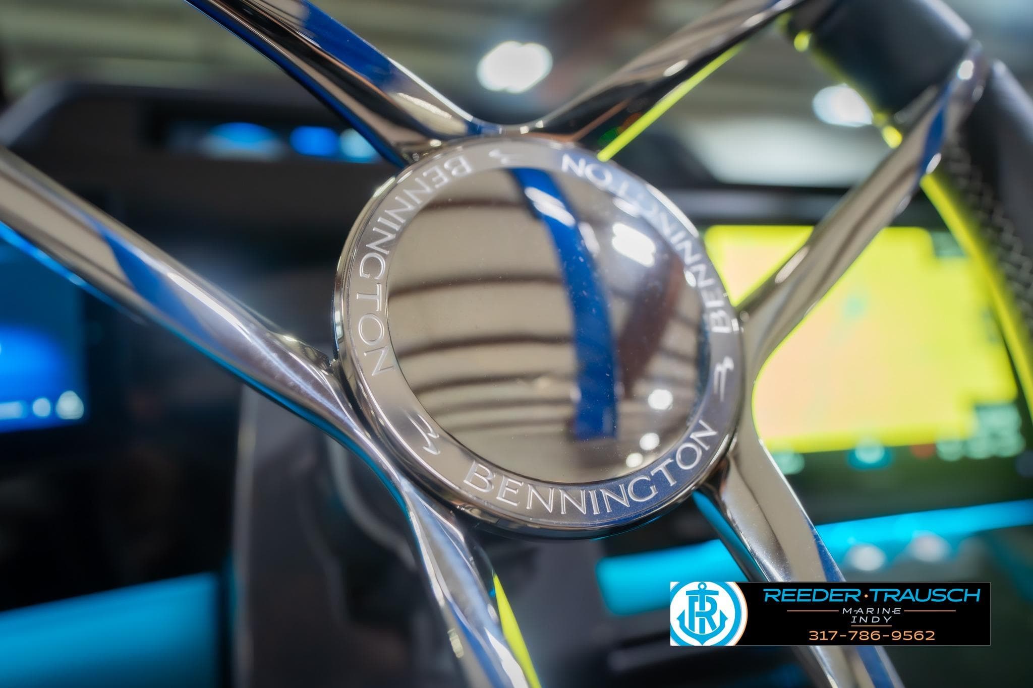 Close-up of 2026 Bennington 27 RX steering wheel with Reeder-Trausch Marine logo.