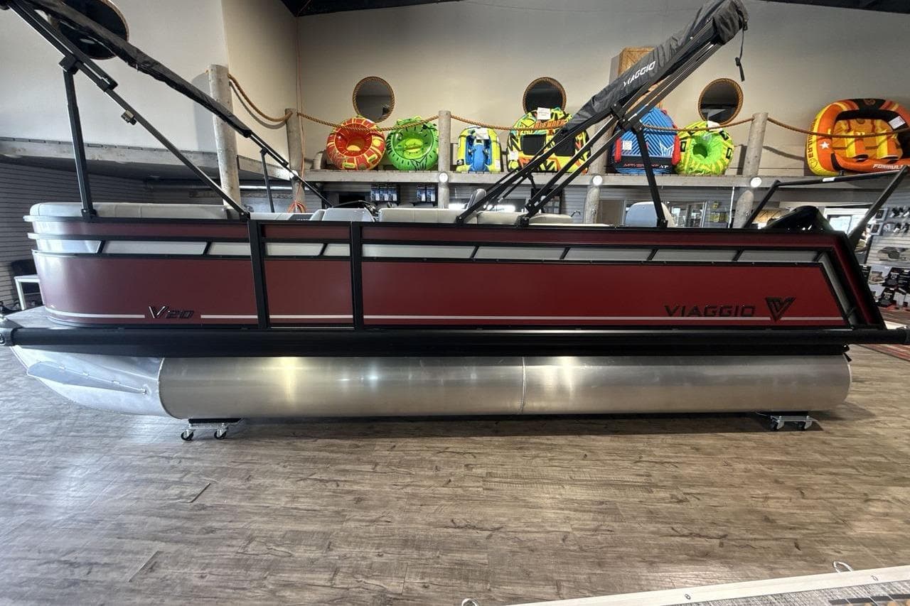 2026 Viaggio V20R pontoon boat displayed indoors with vibrant wall decor.