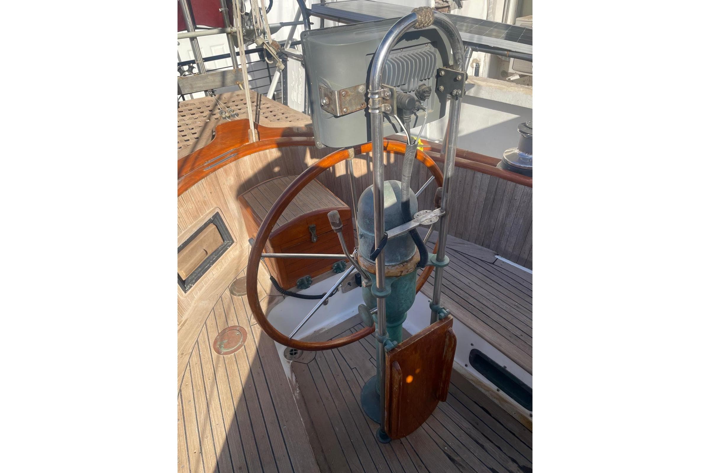 Steering wheel of 1980 Hans Christian 43 sailboat, featuring classic wooden and metal design.