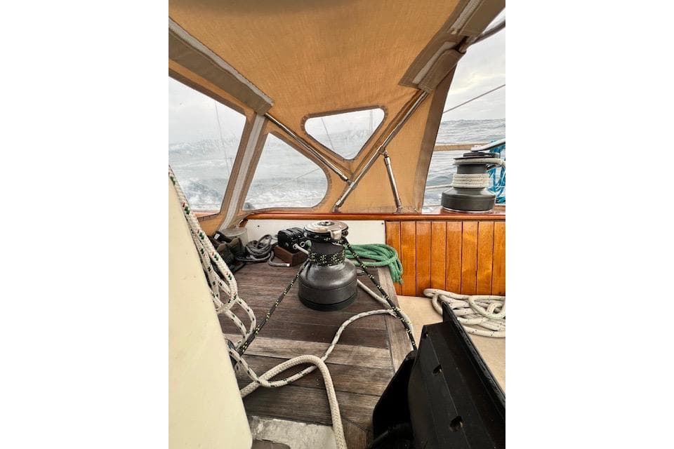 Interior view of 1985 Robert Clark Ketch sailboat with ropes and winch.