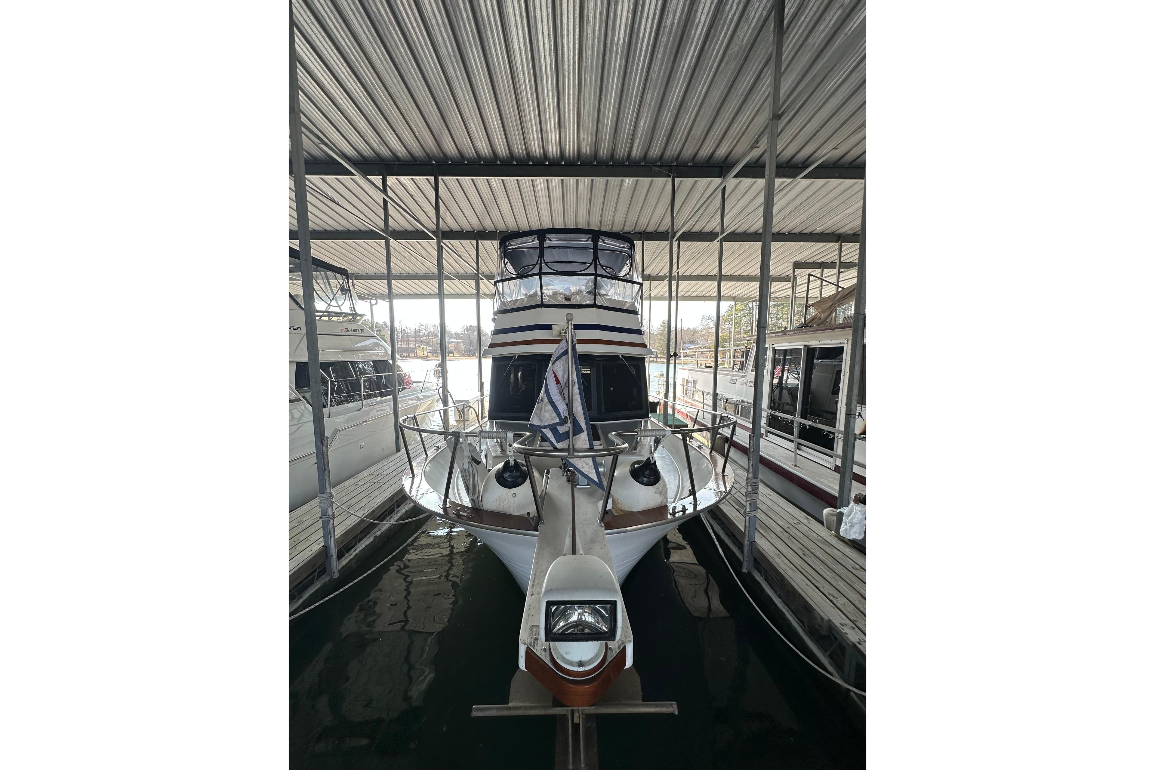 1986 Present Yachts 35 MotorYacht docked in covered marina.