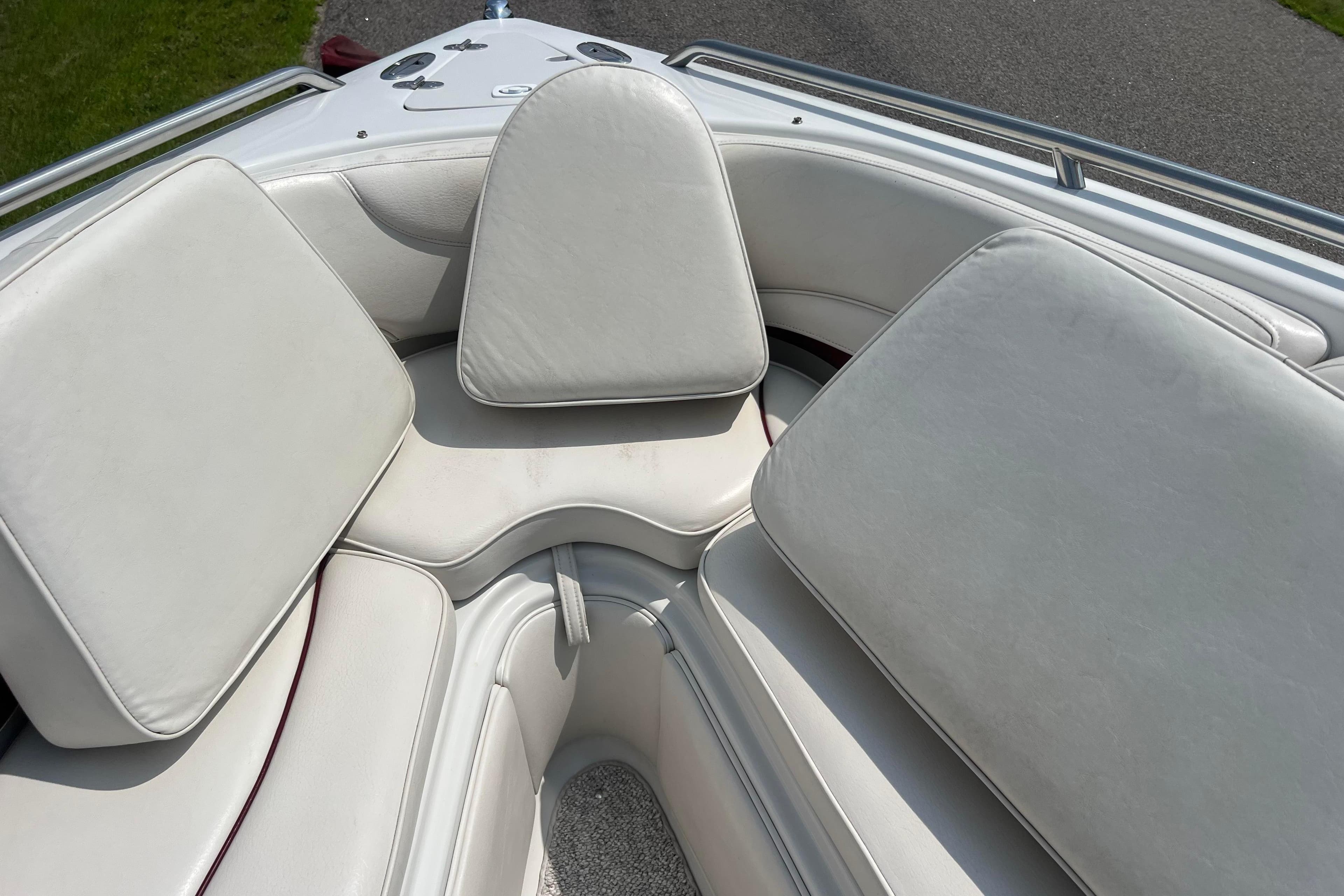 2003 Crownline 230 BR boat interior with white cushioned seating.