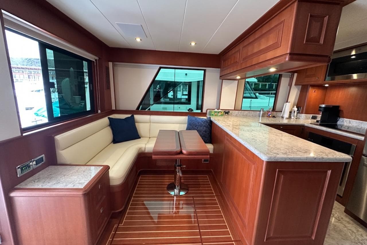 Luxurious 2024 Northwest 55 yacht interior with elegant wood finishes and modern kitchen.