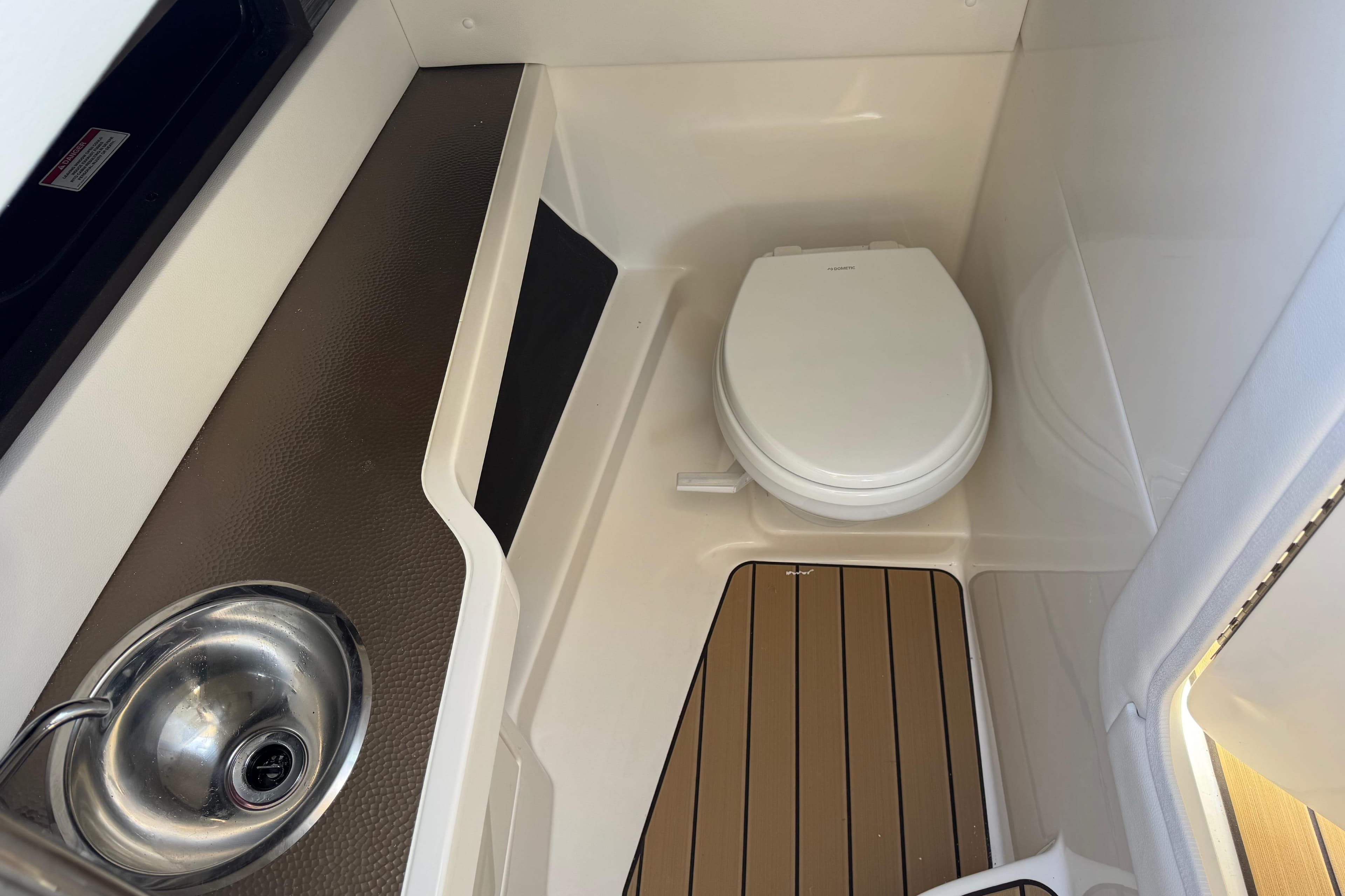 2026 Sea Ray SLX 310 boat bathroom with sink and toilet.