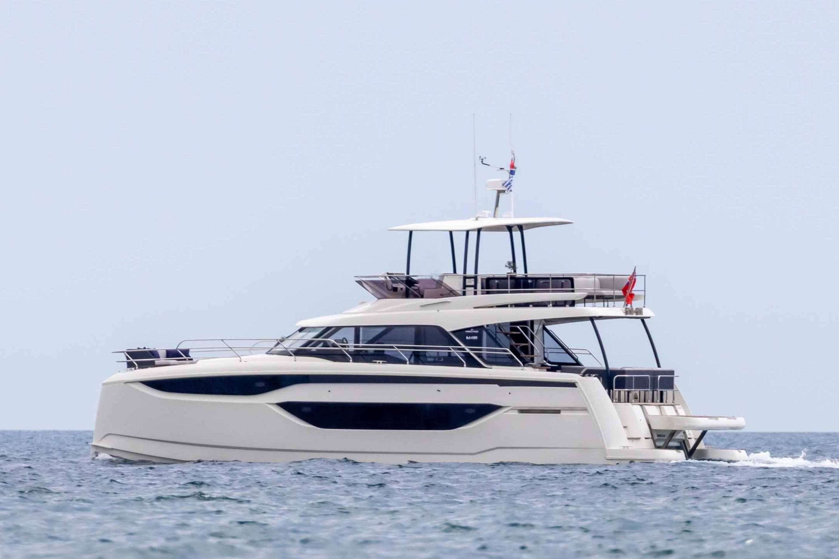 2024 Prestige M48 yacht cruising on open water, showcasing sleek design and luxury features.