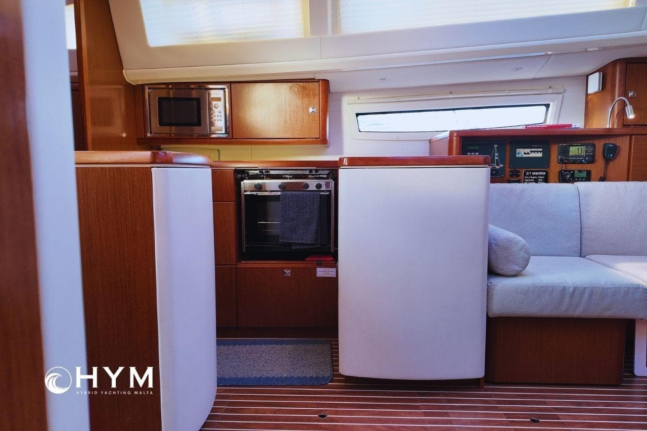 Interior of 2014 Bavaria Vision 46 yacht with modern kitchen and cozy seating area.