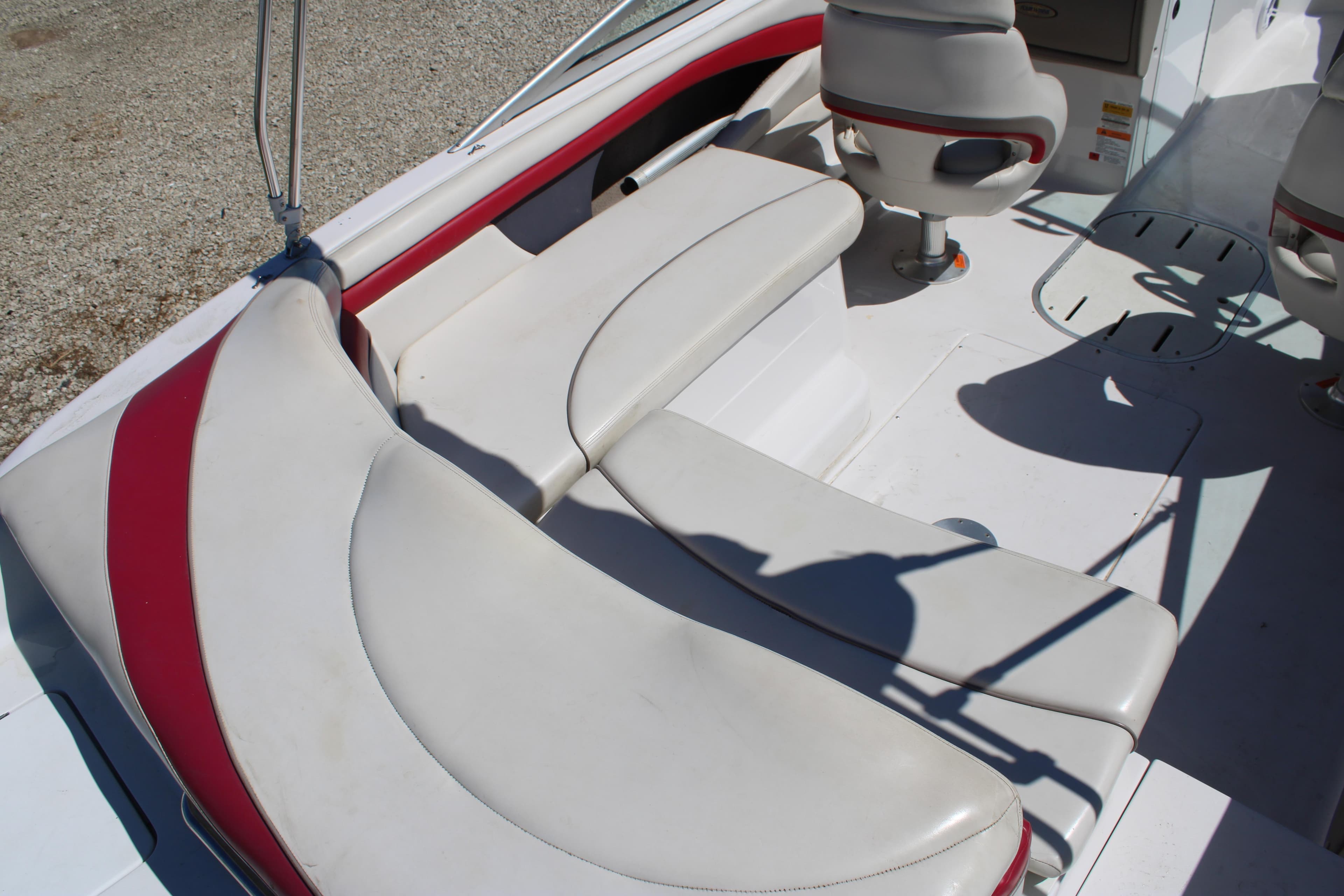 2002 Four Winns 240 Horizon boat interior with white and red seating arrangement.