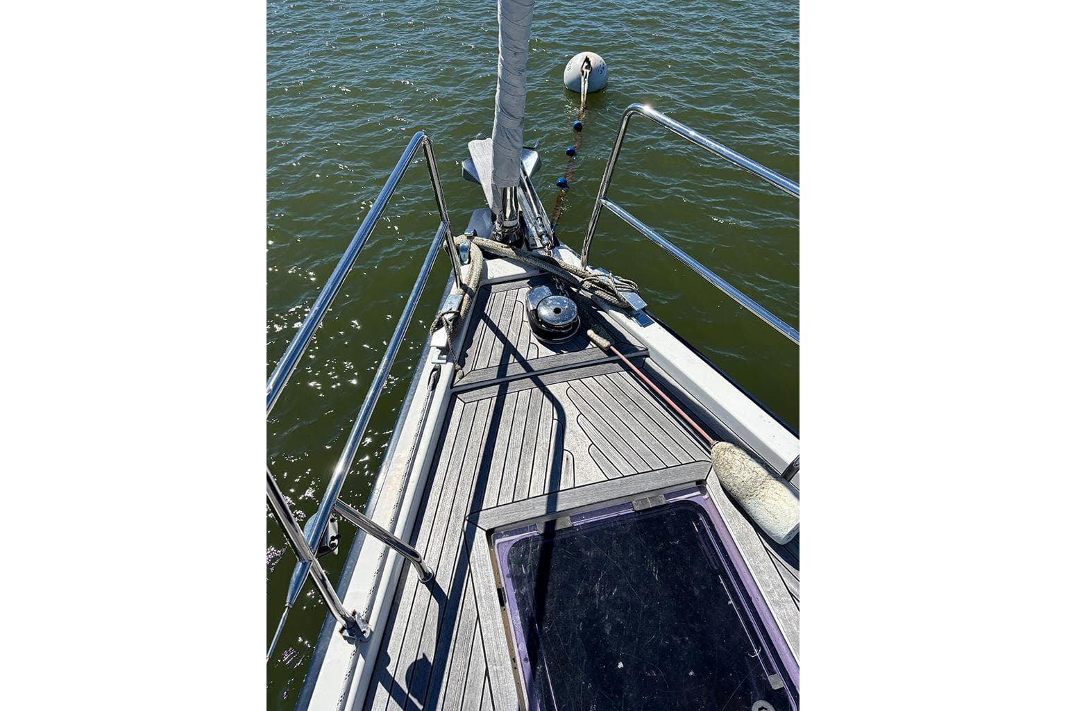 Bow of 2014 Hanse 445 sailboat with deck details and railing.