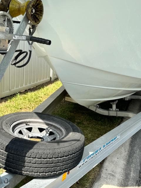 2013 Sea Fox 286 CC boat on a trailer with a spare tire.
