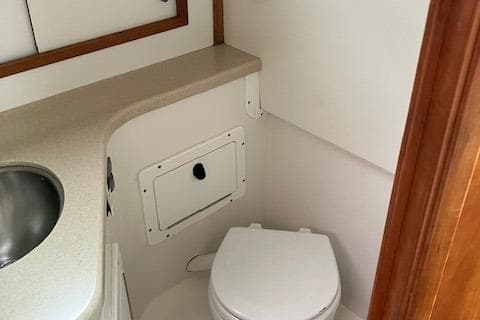 2005 Back Cove Downeast Hardtop boat bathroom with sink and toilet.