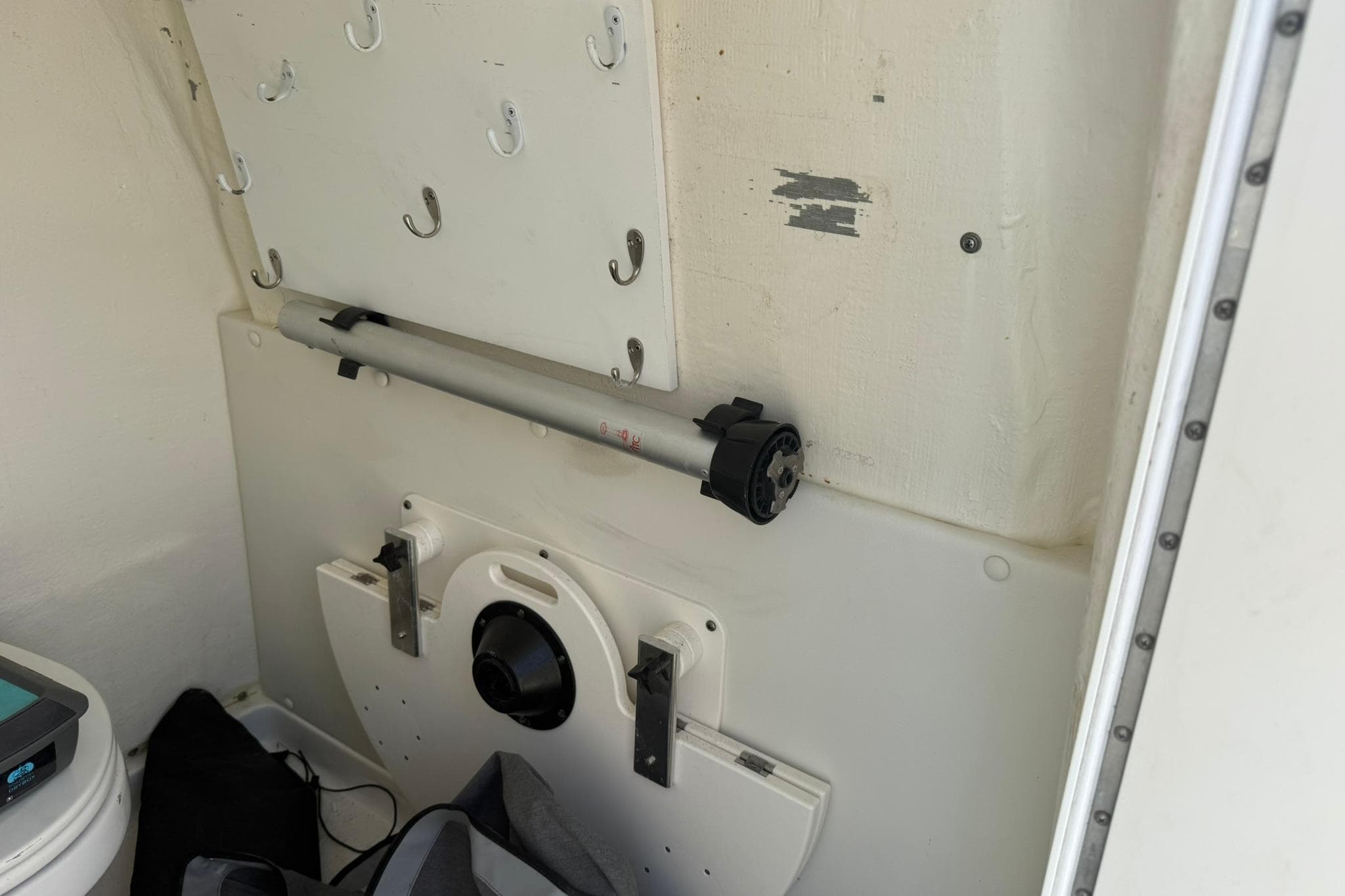 Interior of a 2020 World Cat 325 CC boat, featuring storage hooks and equipment.