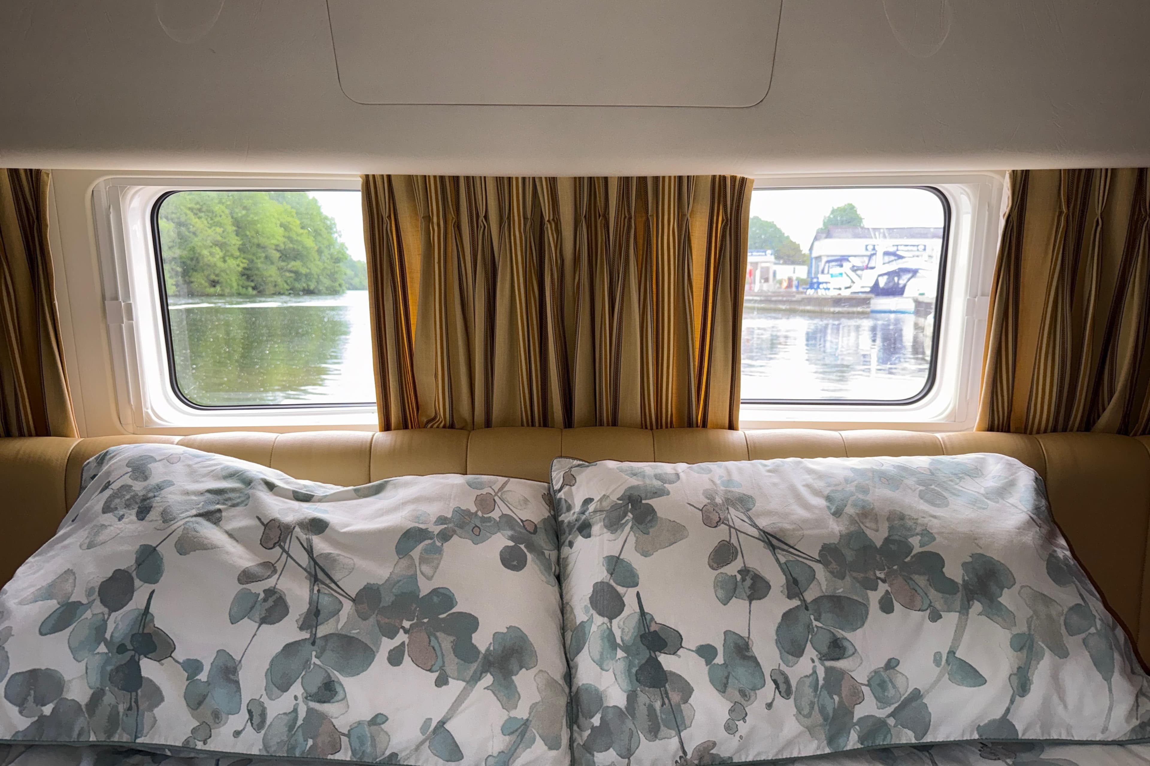 Interior view of a 2004 Broom 42 CL boat cabin with scenic window views.