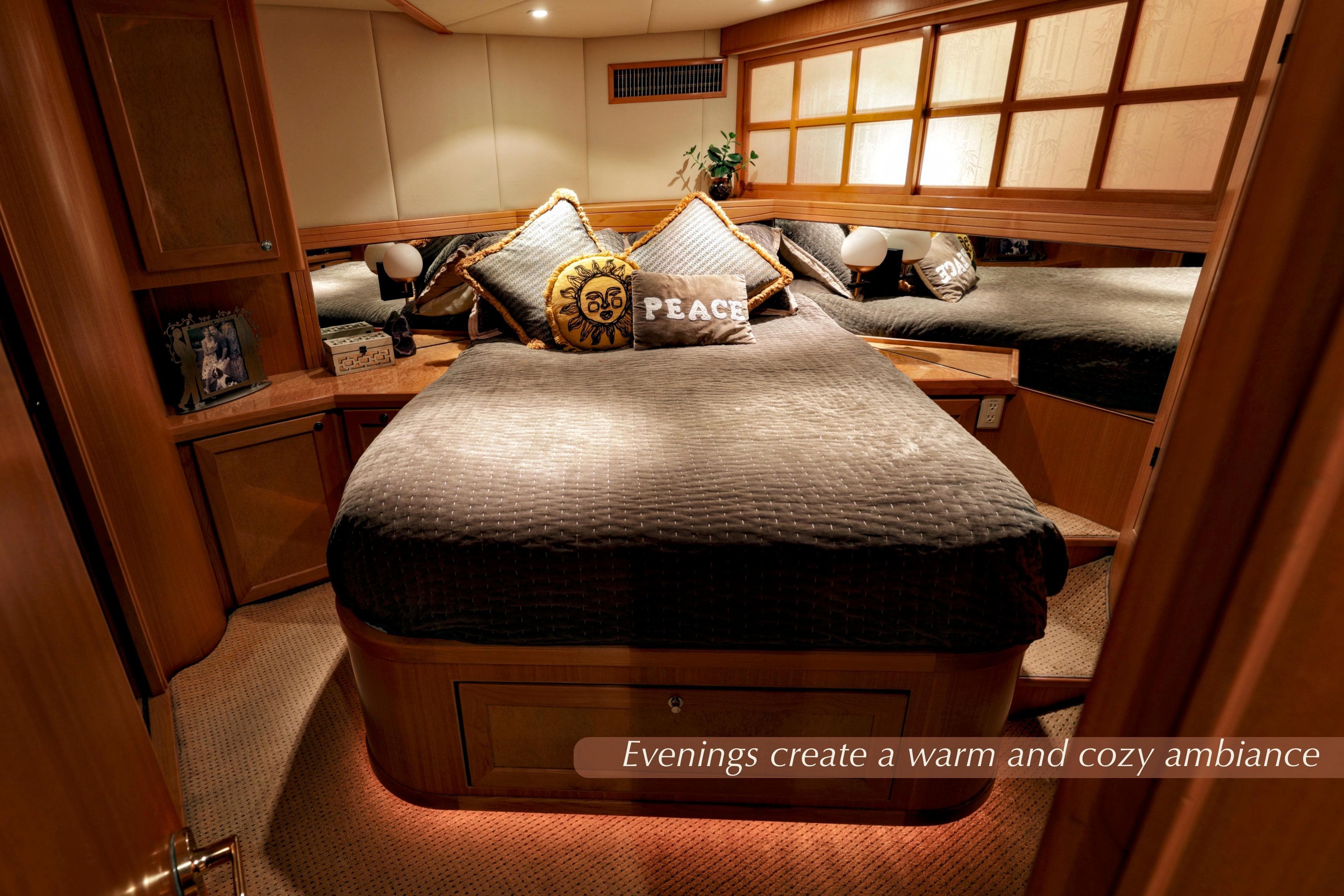Luxurious 2004 McKinna 57 Pilothouse bedroom with warm lighting and cozy decor.