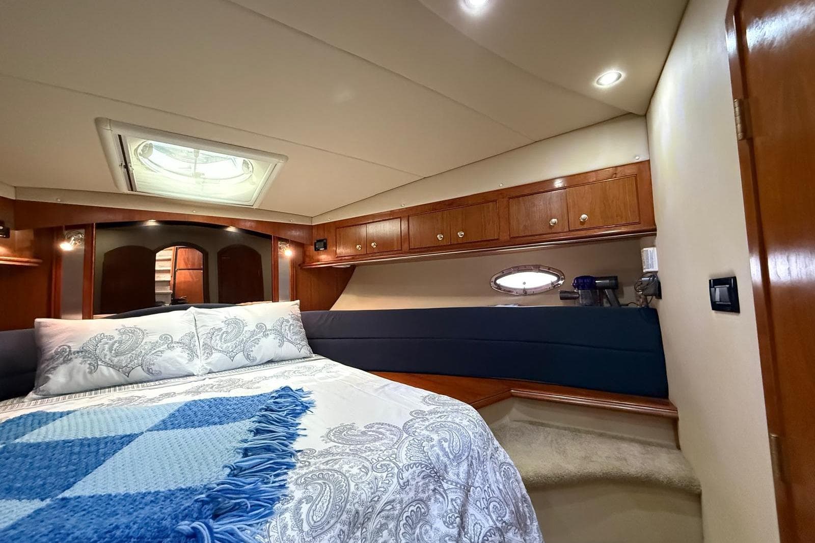 Luxurious bedroom interior of 2005 Cruisers Yachts 455 Express Motoryacht with elegant bedding.