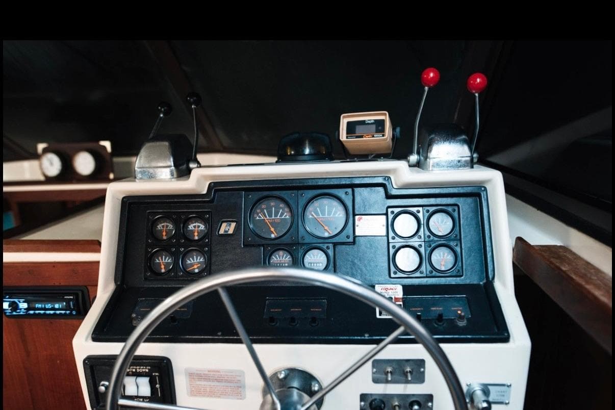 1982 Trojan F-36 Convertible boat dashboard with gauges and steering wheel.