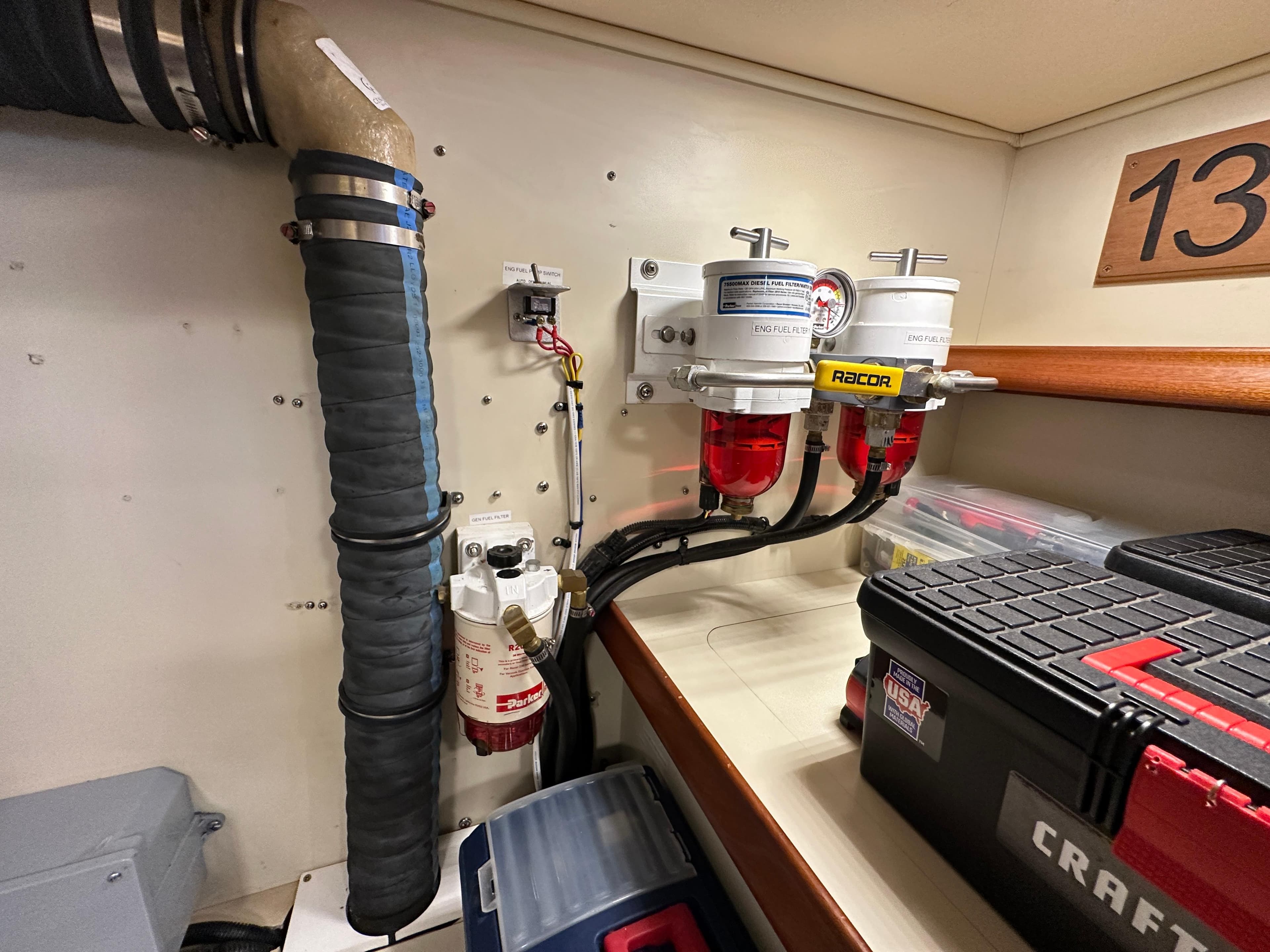 Engine room of 2021 Island Packet 439 with fuel filters and toolboxes.