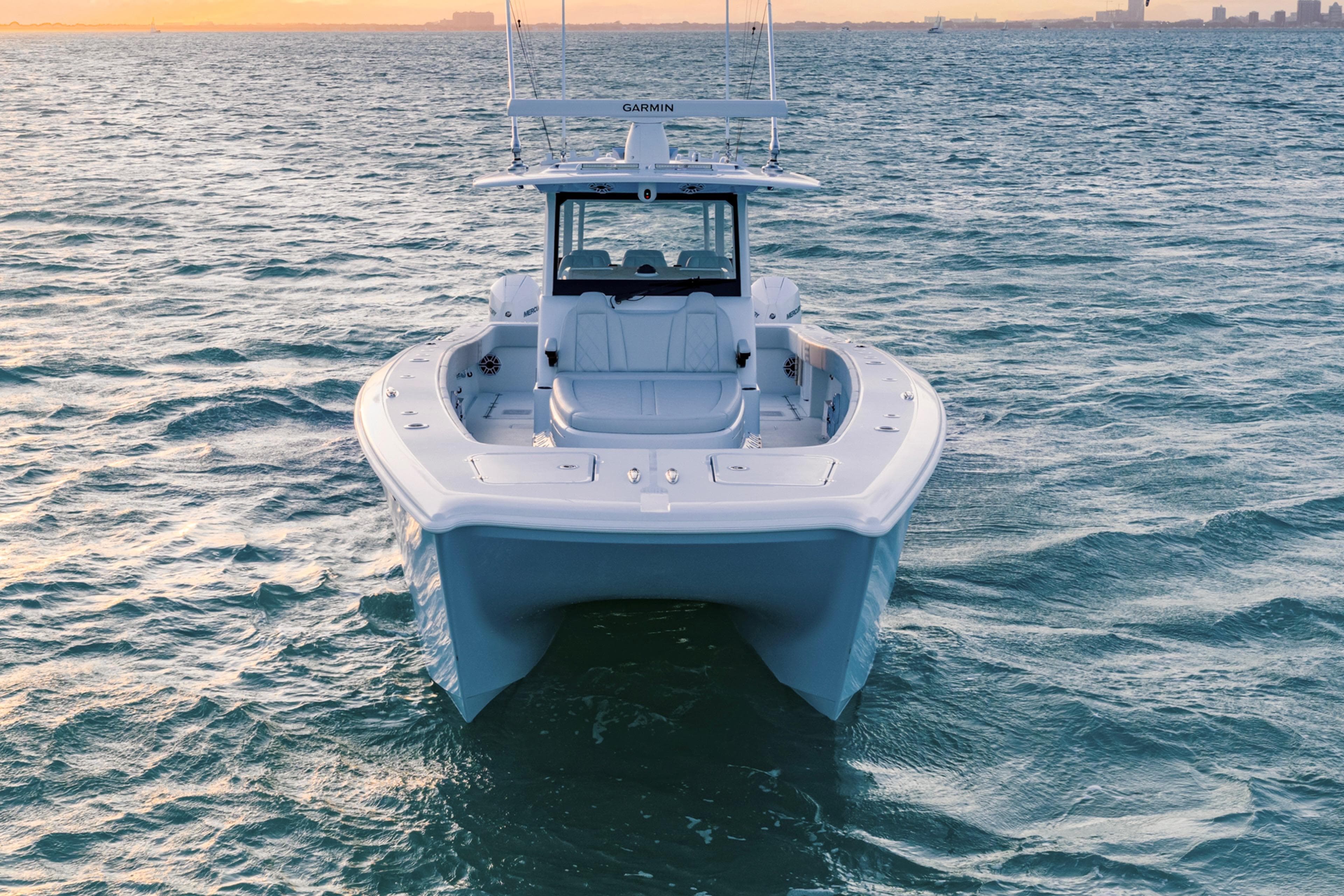 2026 Freeman 38 boat on open water at sunset.