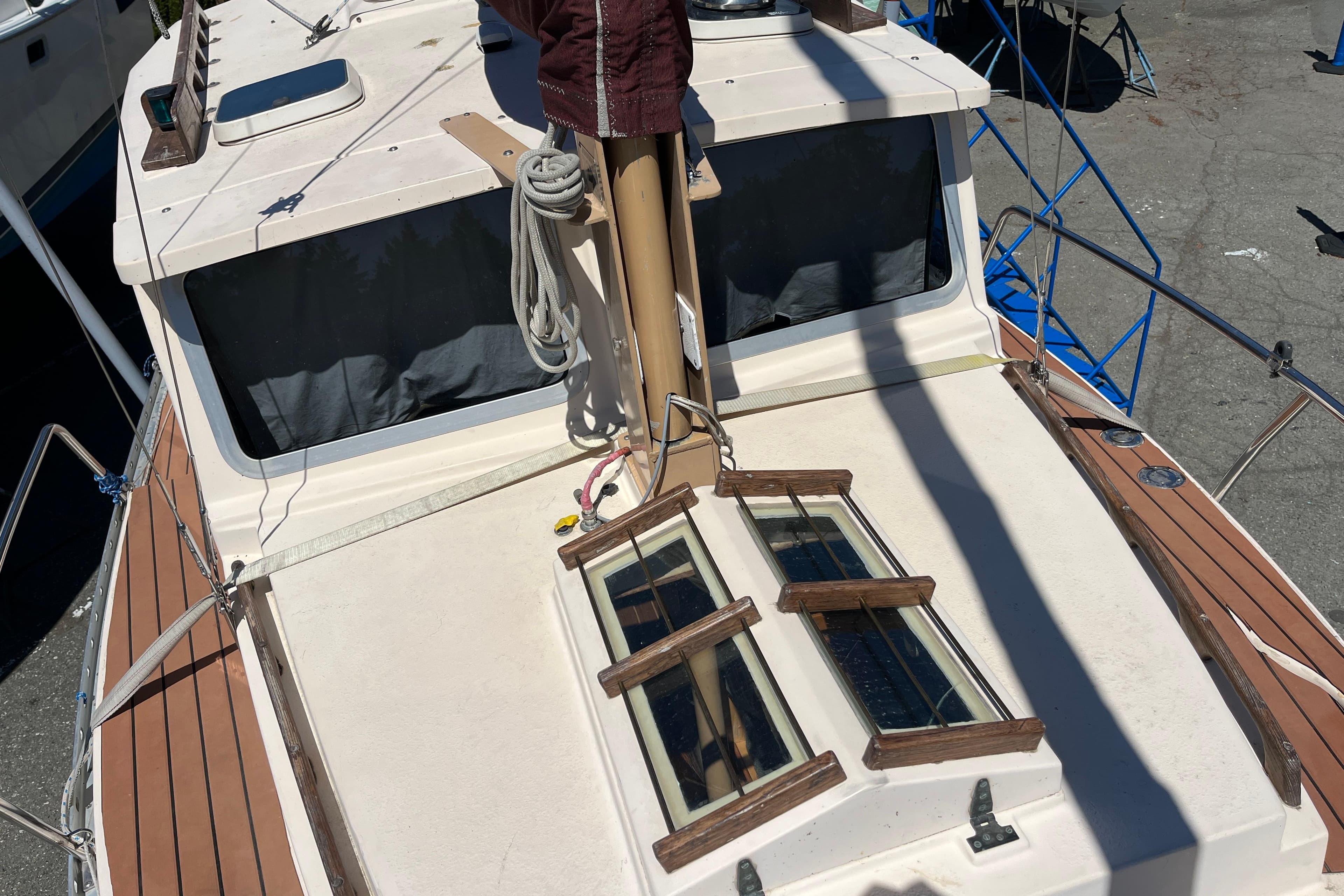 1994 Nimble Kodiak Pilothouse Motor Sailor deck with wooden accents and windows.