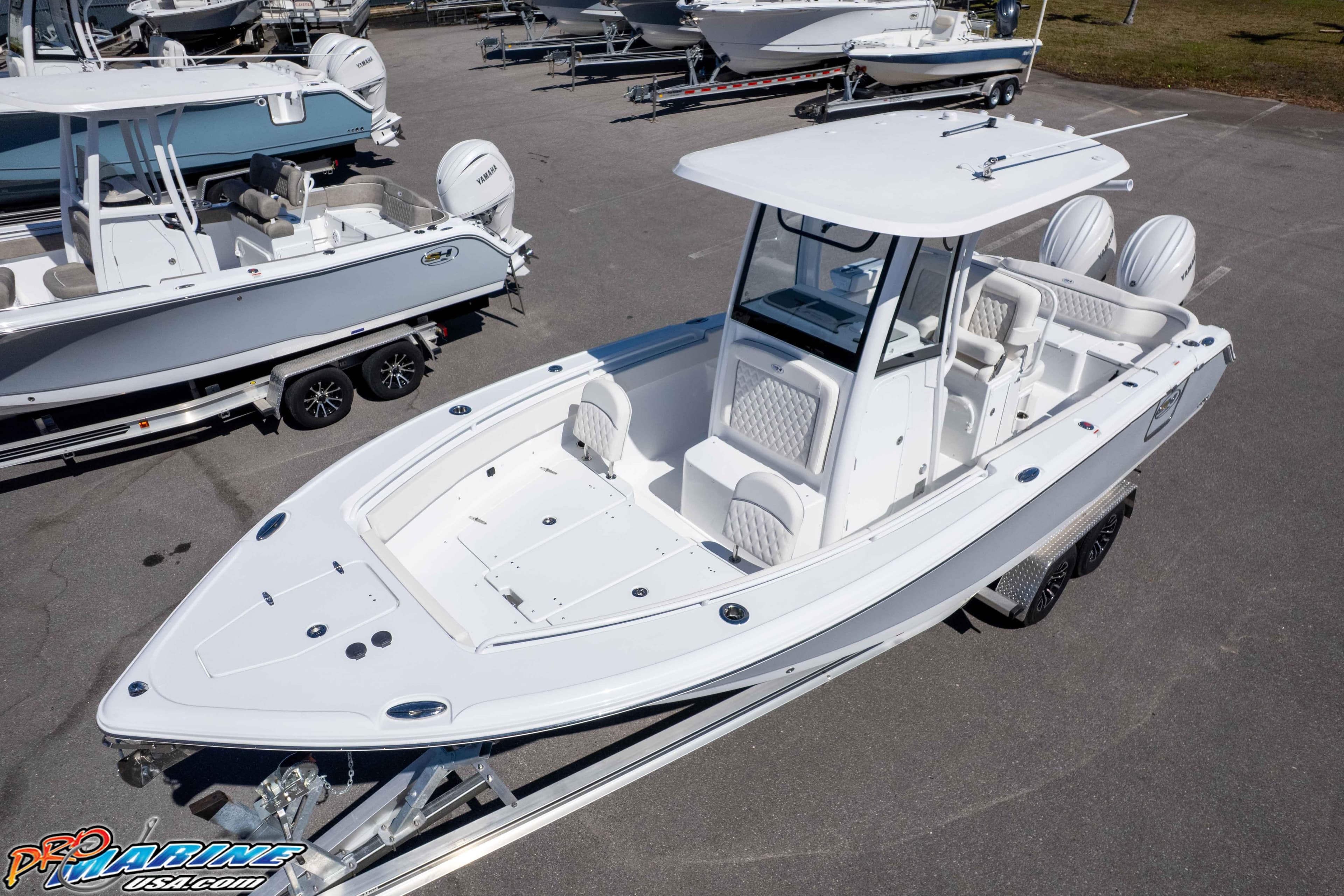 2026 Sea Hunt Ultra 265 SE boat on trailer, displayed in a marina setting.