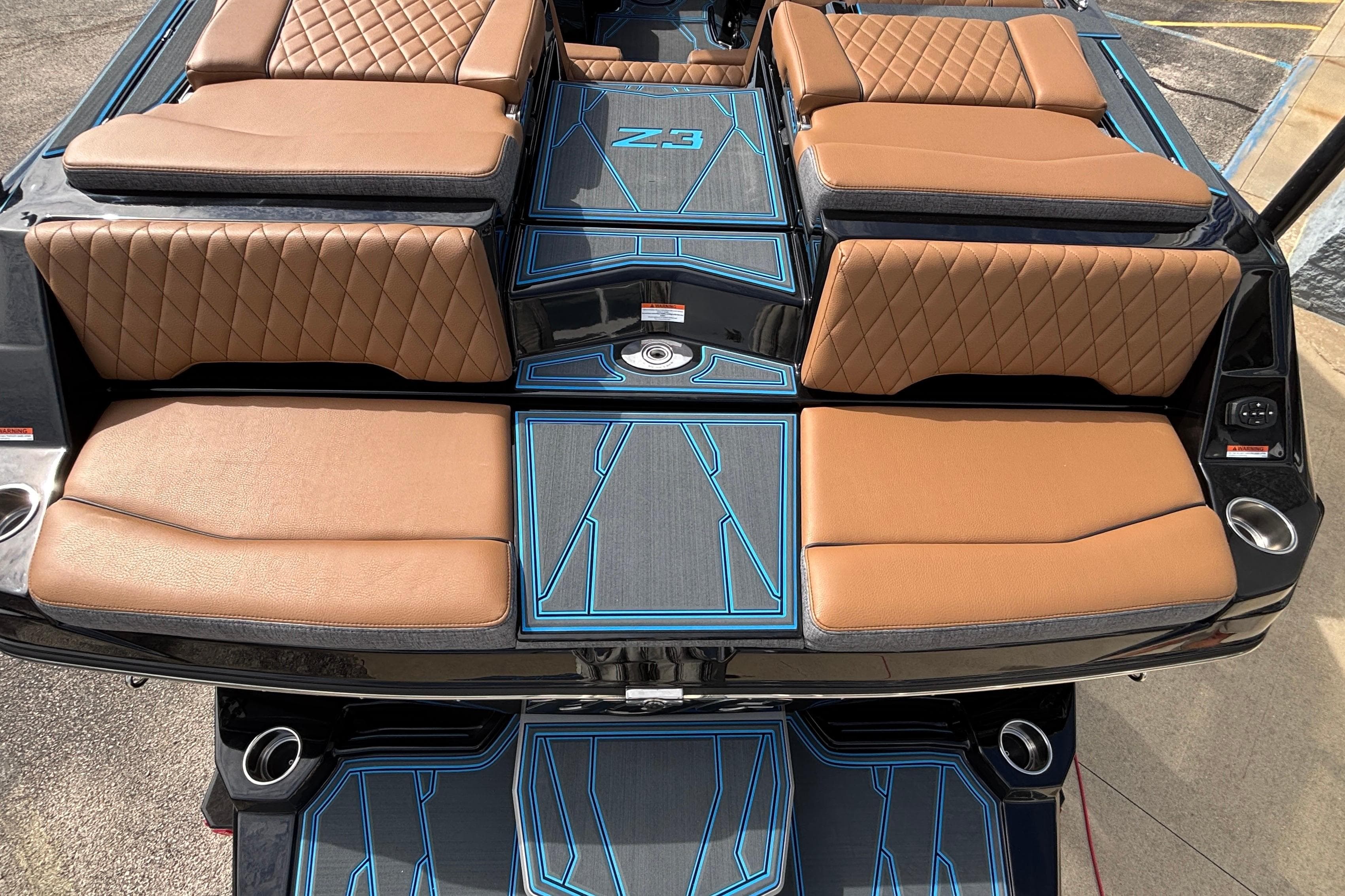 2026 Tigé Z3 boat interior with tan quilted seats and blue-accented flooring.