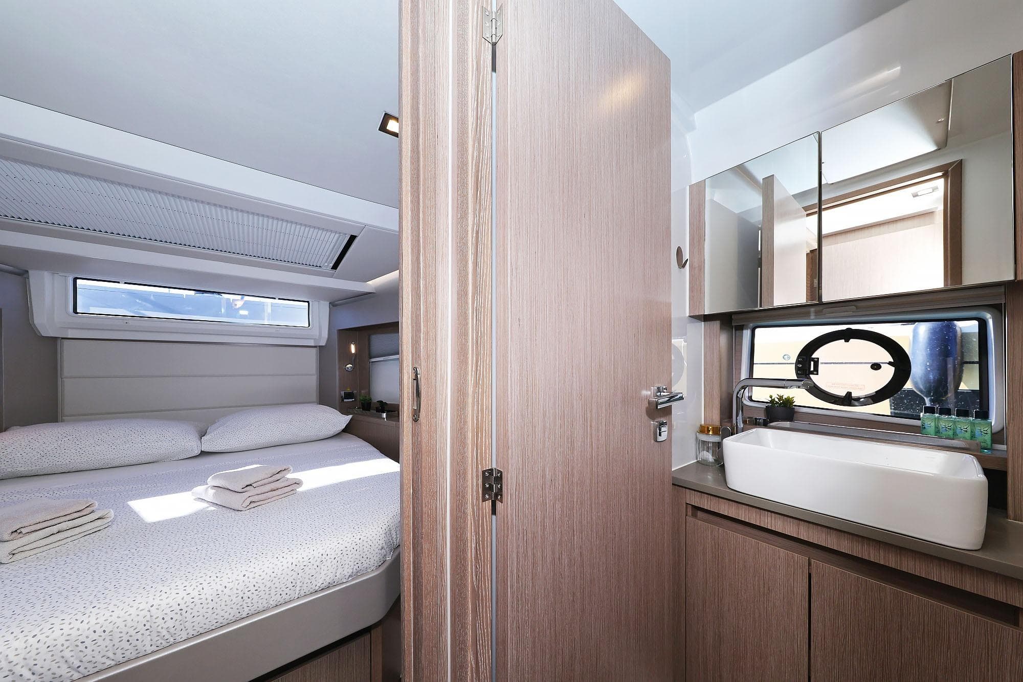Luxurious interior of 2024 Sealine C390 yacht featuring bedroom and bathroom.