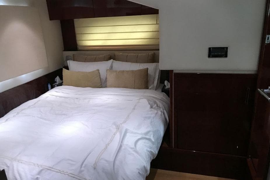 Luxurious bedroom interior of 2010 Sea Ray Sundancer 540 yacht with cozy bedding.