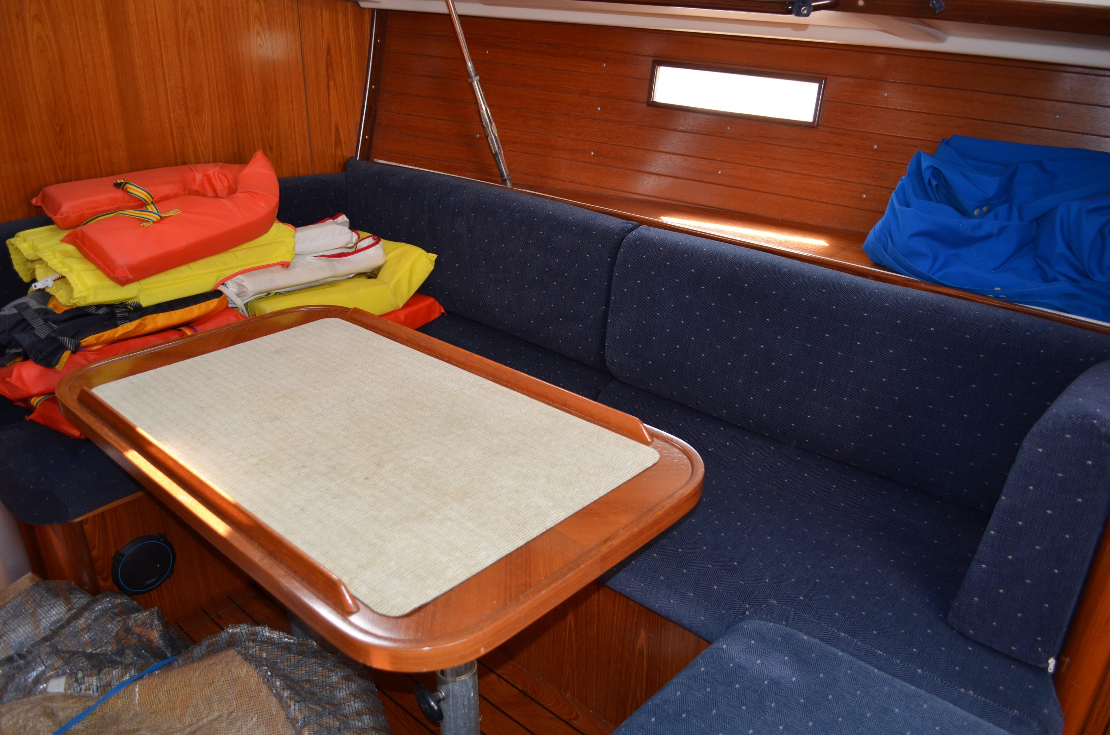 Interior of 1993 Beneteau Oceanis 370 sailboat with cozy seating and table.