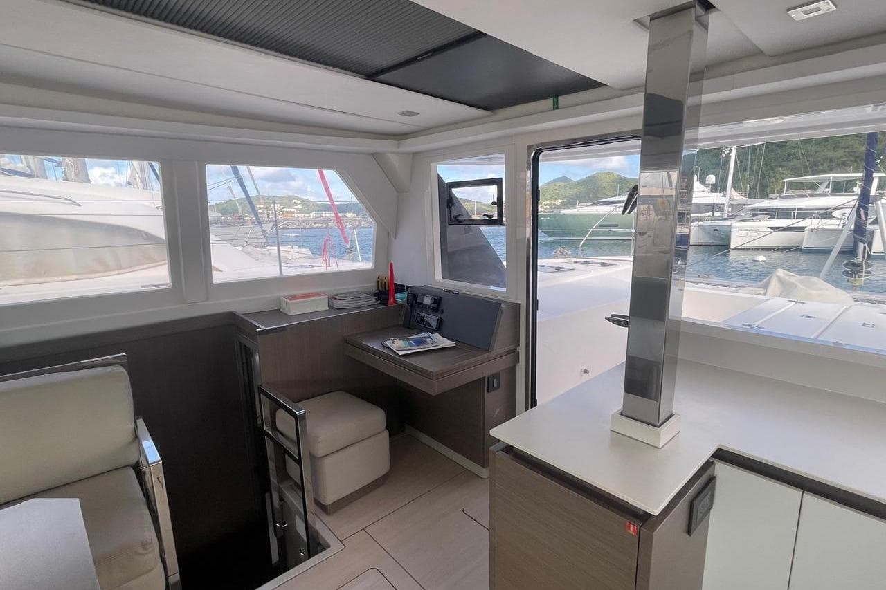 Modern interior of 2022 Leopard 42 yacht with marina view through large windows.
