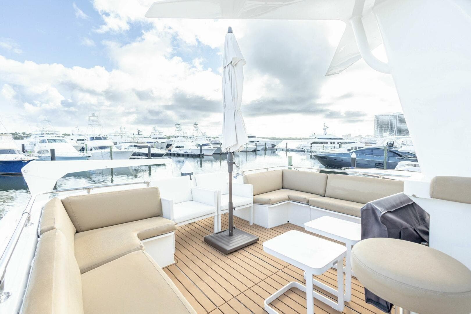 1989 Hatteras Custom Cockpit yacht with spacious seating, docked at a marina under cloudy skies.