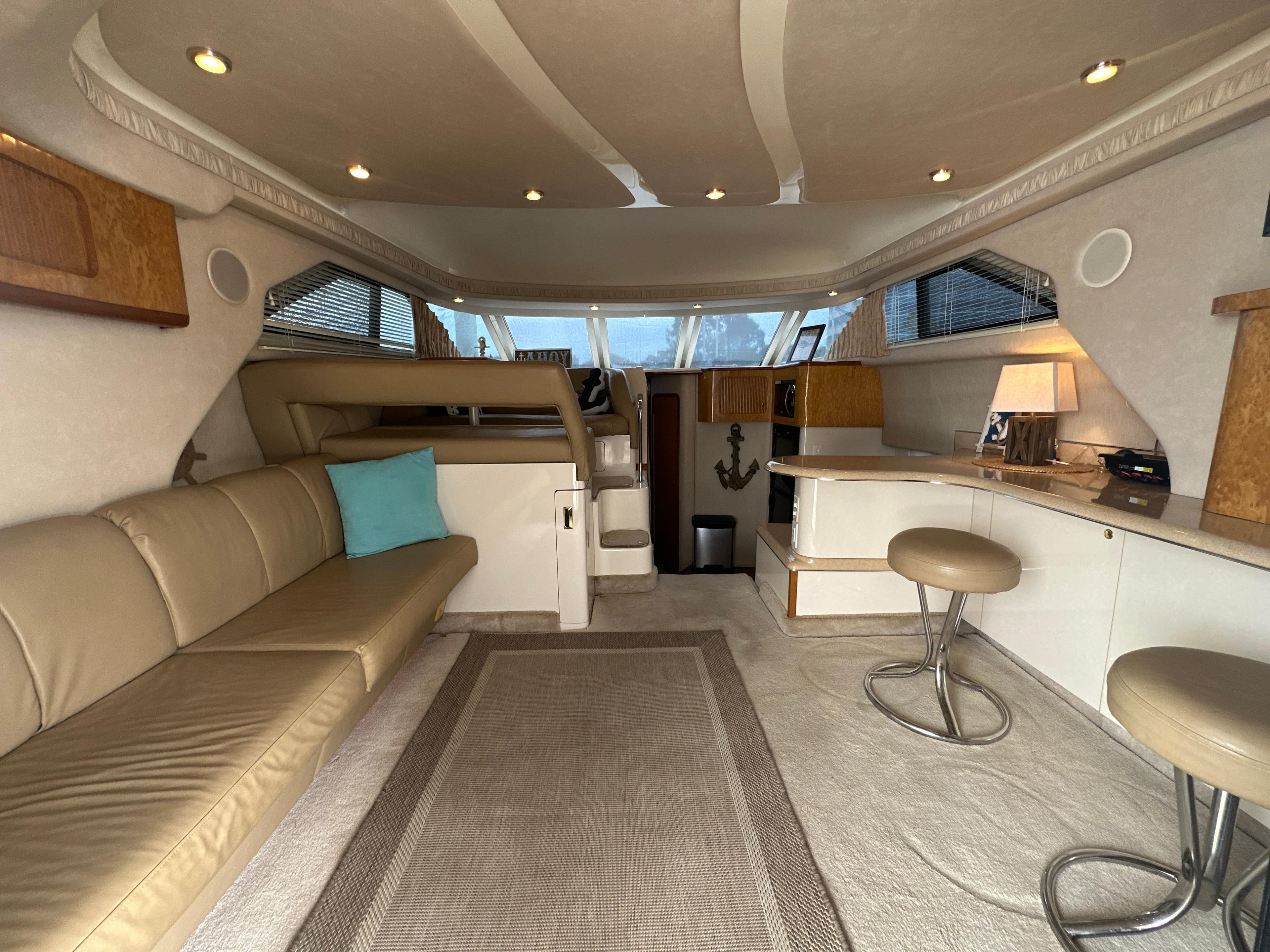 Interior of 1997 Sea Ray 400 Sedan Bridge yacht with beige seating and modern decor.