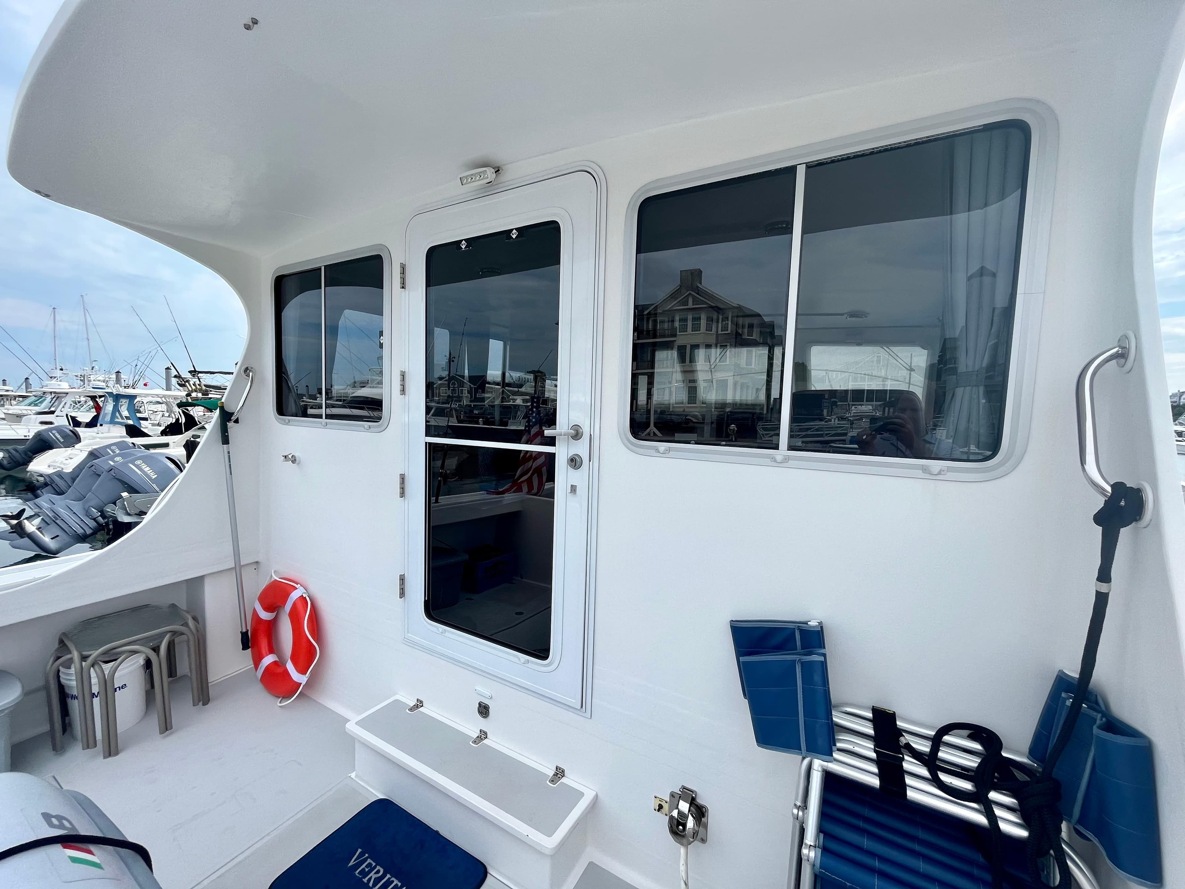 2016 Wesmac 42 boat deck with seating, life preserver, and marina view.