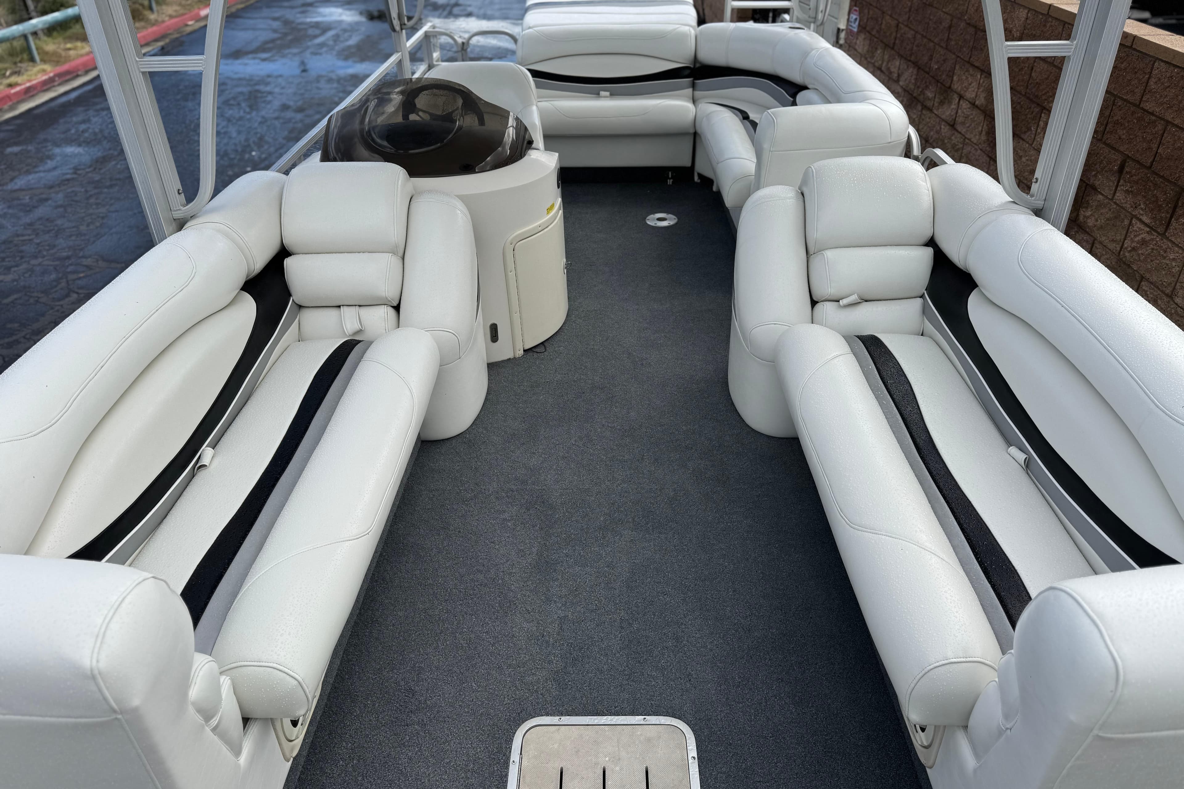 2006 Bennington 2875RLTD I/O boat interior with white seating and carpeted floor.