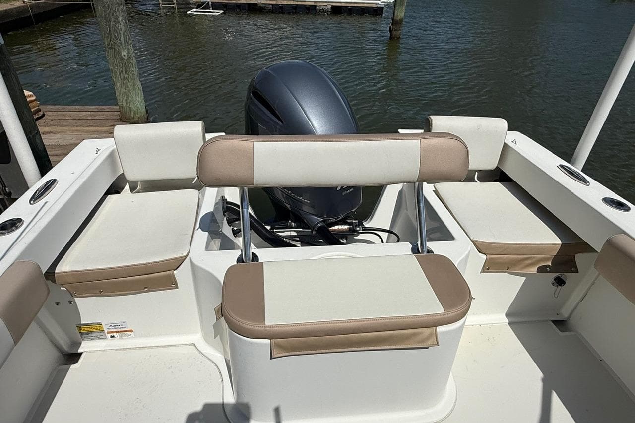 2019 Parker 2150 boat interior with cushioned seating and outboard motor.