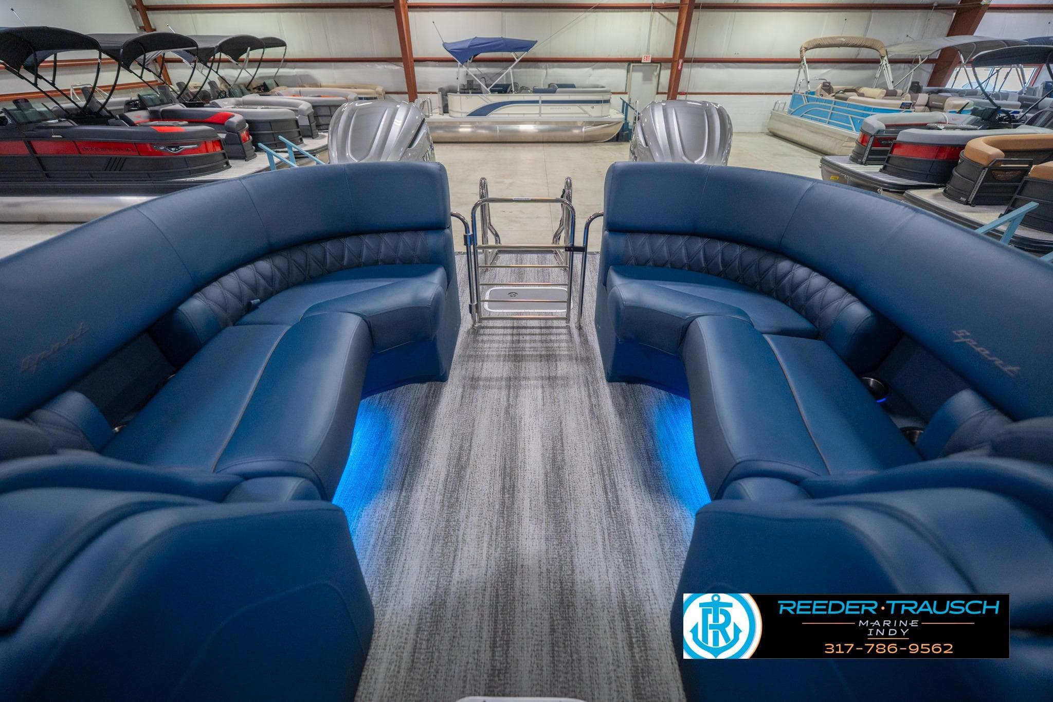 2026 Bennington 27 RX pontoon boat interior with blue seating and ambient lighting.