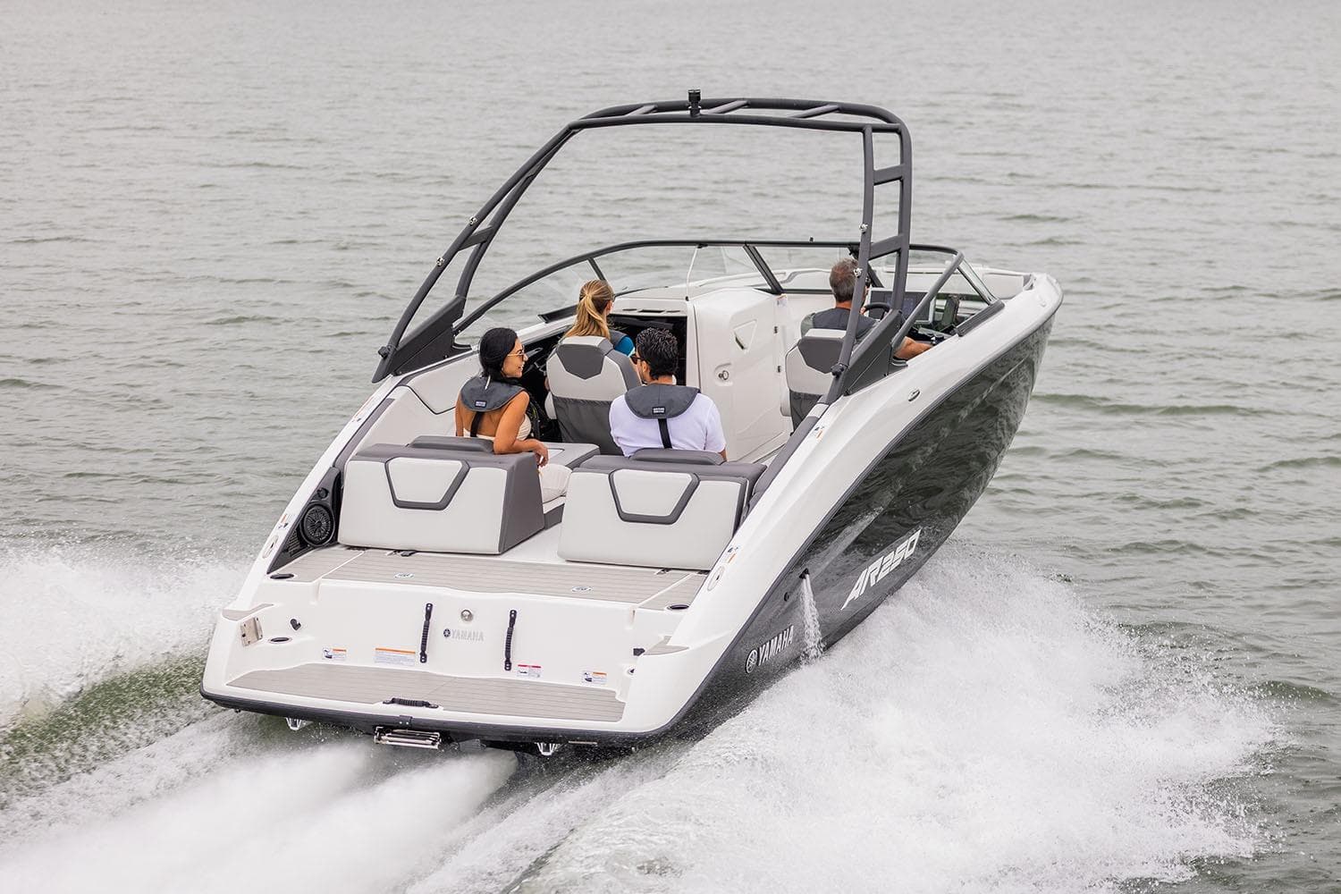Manufacturer Provided Image: 2026 Yamaha Boats AR250 cruising on water with passengers enjoying the ride.