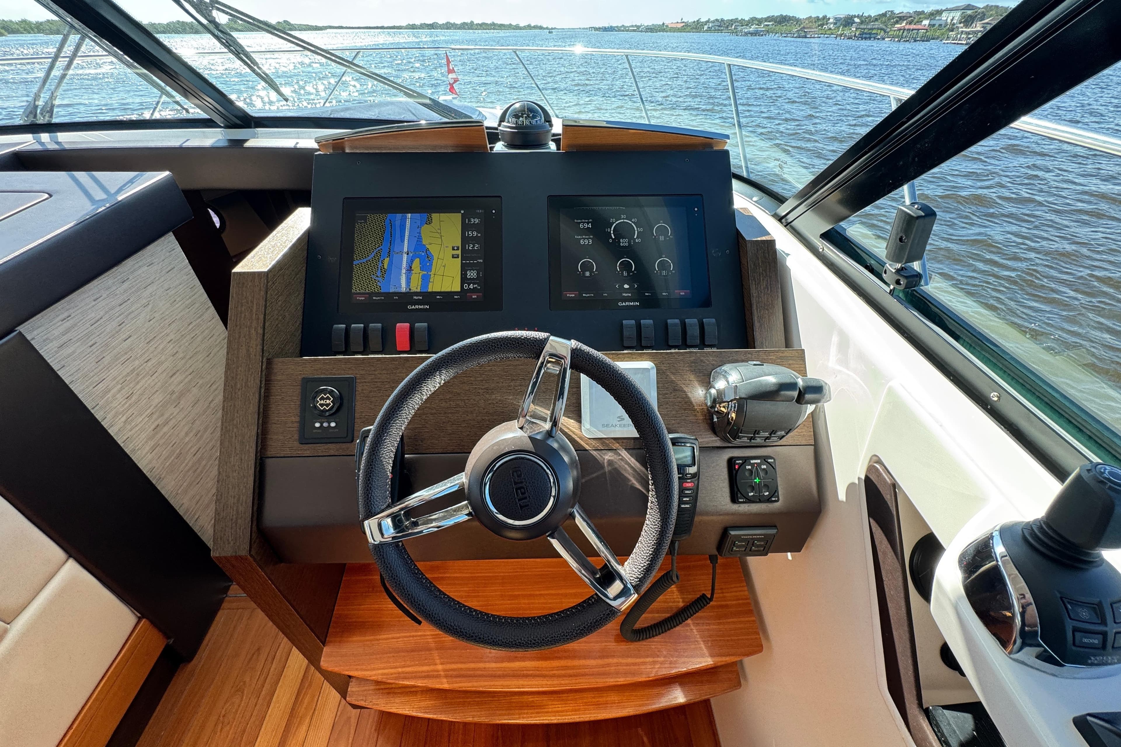 2016 Tiara Yachts C44 Coupe helm with navigation screens and steering wheel.