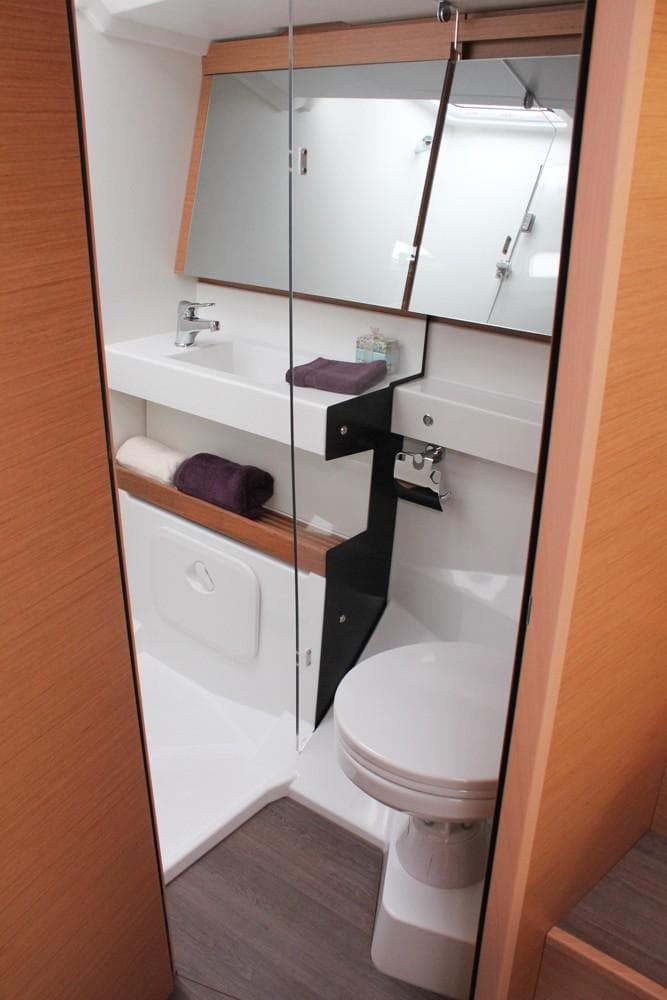 Modern bathroom in 2025 Jeanneau Sun Odyssey 440 yacht, featuring sleek design and amenities.