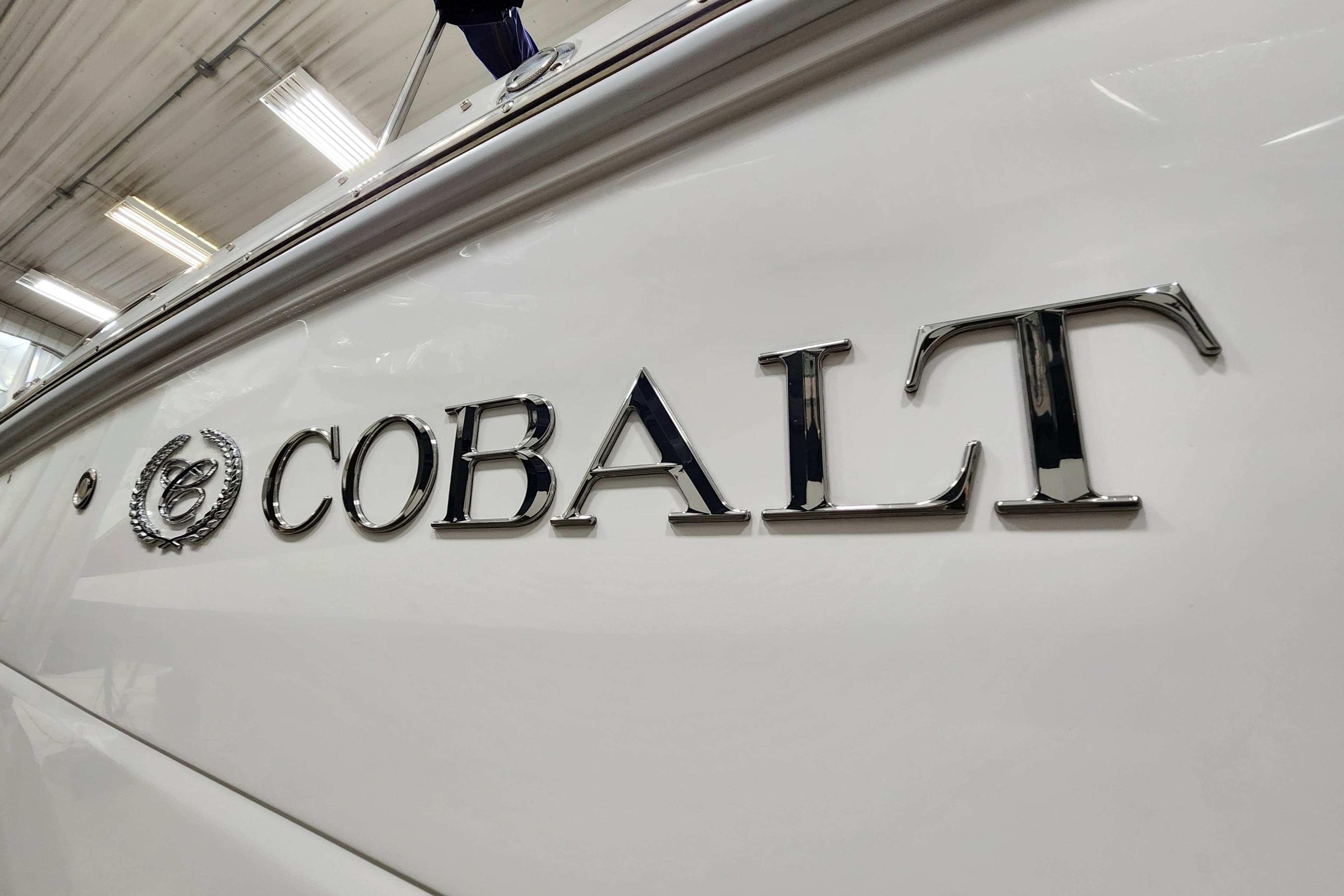 2012 Cobalt 296 boat logo in a showroom setting.